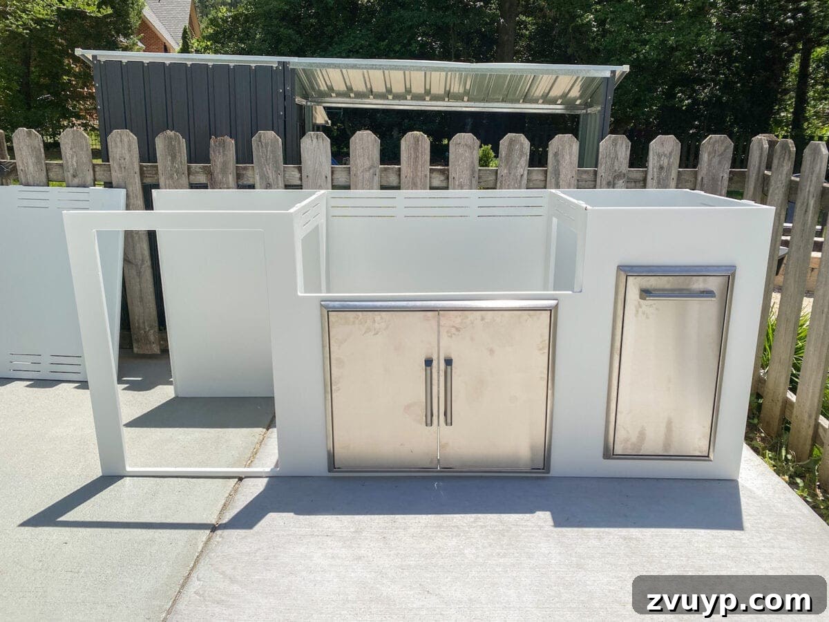 Effortless DIY Outdoor Kitchen Kit Build: Essential Tips 10 Installing a Coyote outdoor grill into the modular outdoor kitchen frame, demonstrating the easy integration of pre-assembled appliances.