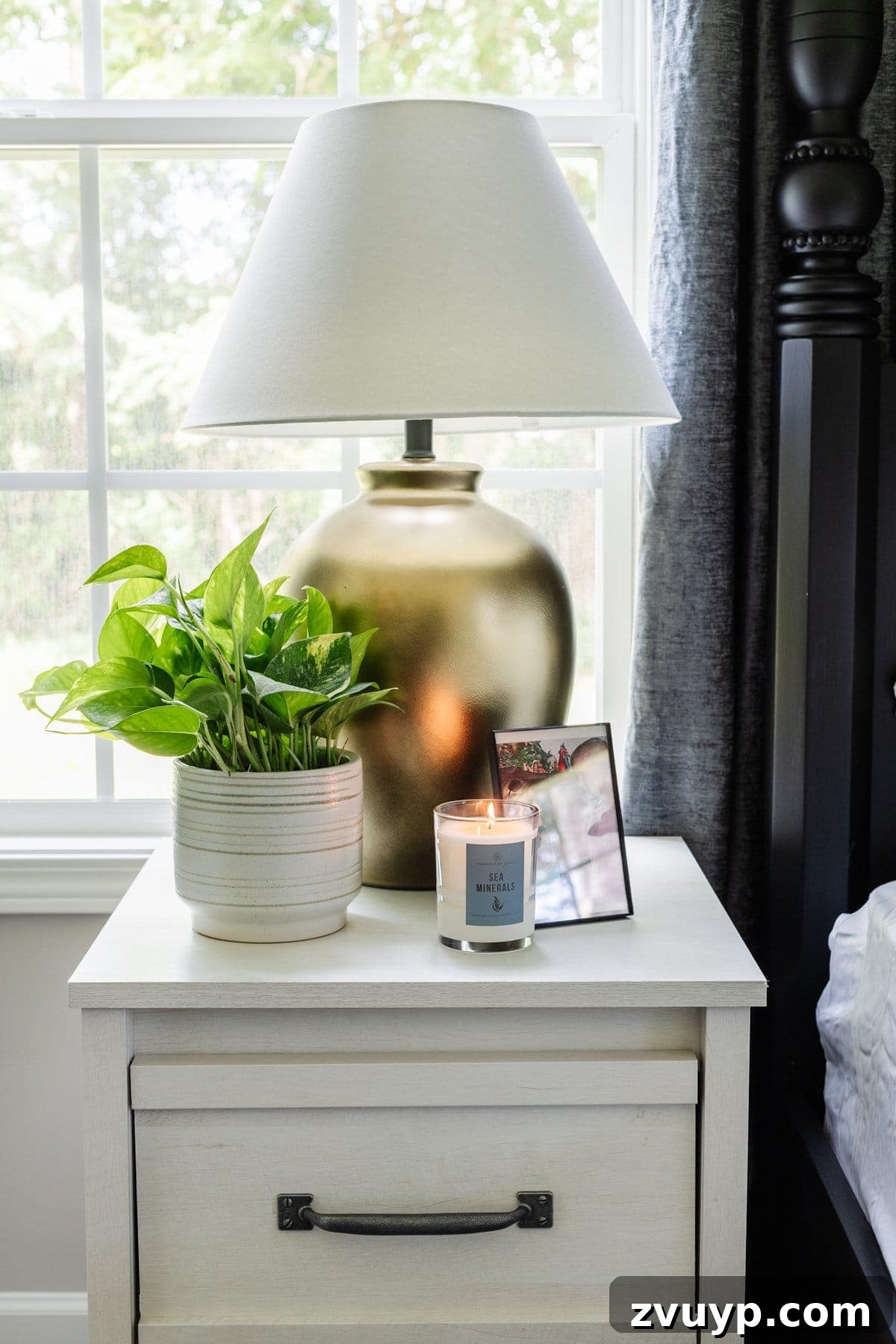 nightstand decor in small bedroom with plant table lamp and candle