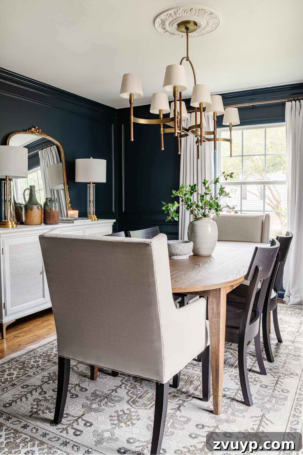 Bassett BenchMade Classic Modern Dining Refined 14 Classic modern dining room showcasing a mid-century modern dining table, navy walls, black chairs, French mirror, and white buffet
