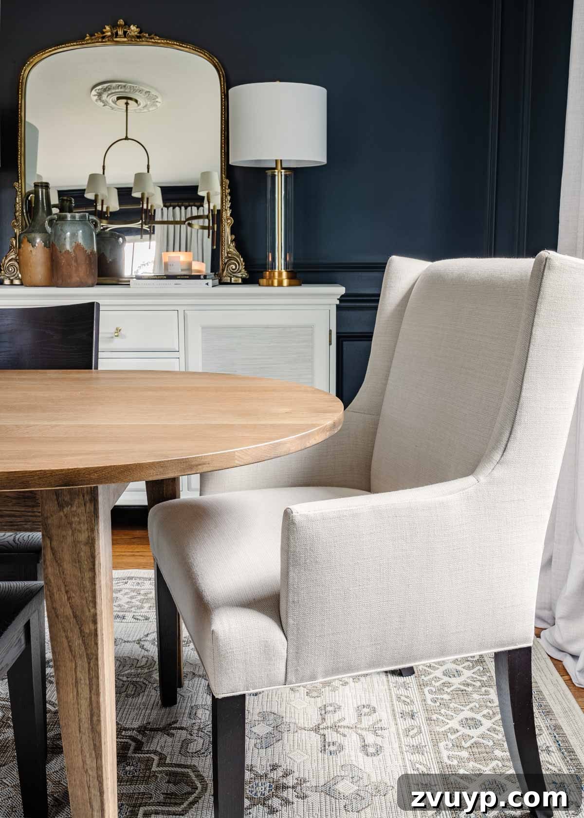 Bassett BenchMade Classic Modern Dining Refined 9 Midcentury modern dining table paired with upholstered and wood chairs, against navy walls and a French mirror