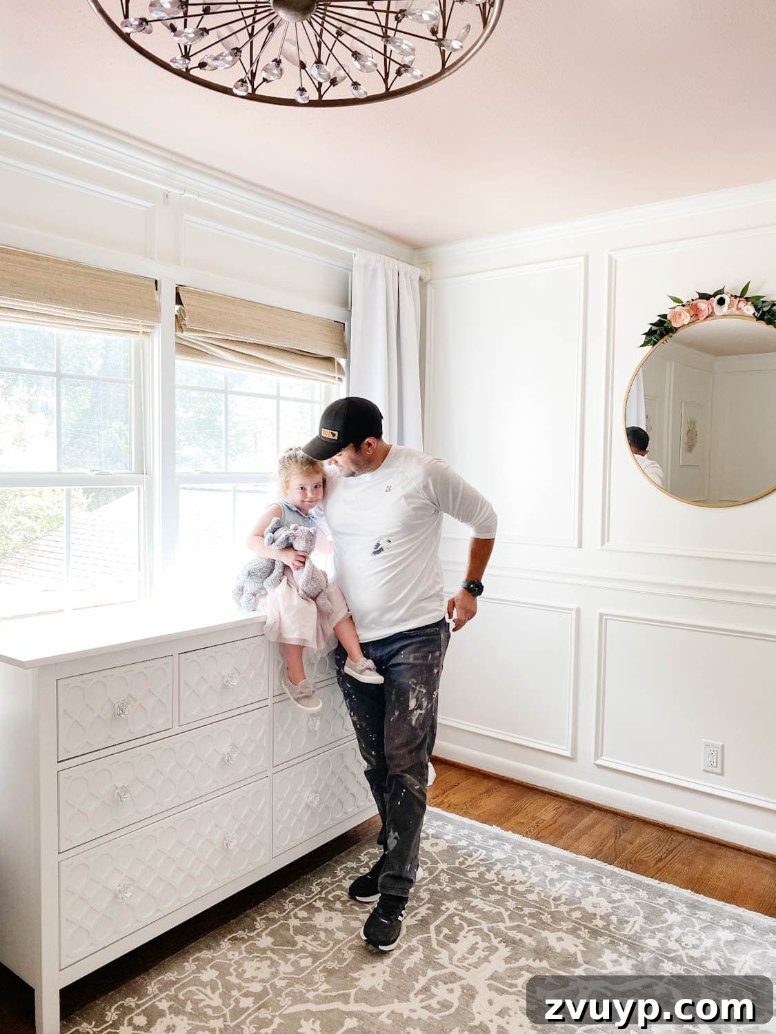 Blush pink paint on a ceiling with a chandelier, creating a warm, inviting glow in the room.