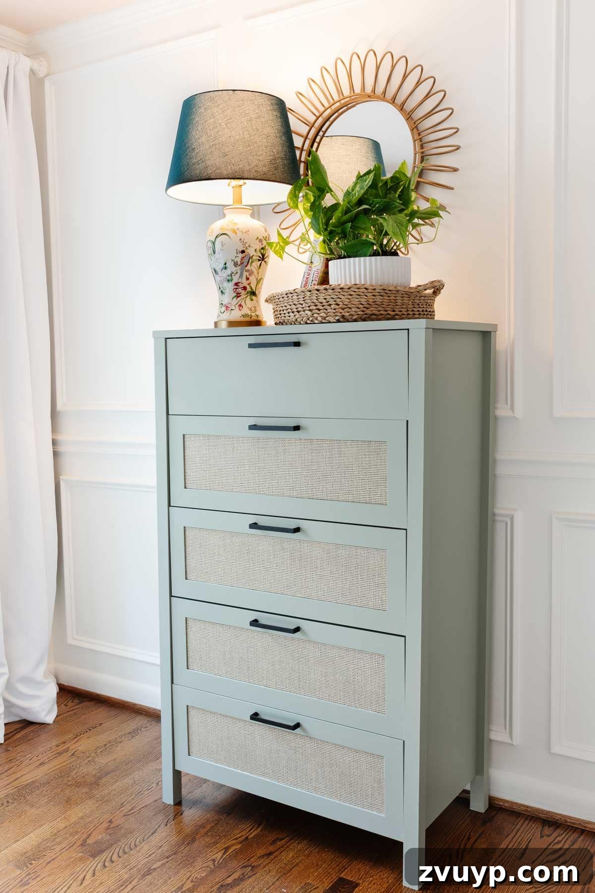 Regan's Room Transformation Painting Laminate Furniture 13 Beautifully updated sage green dresser styled with charming decor, serving as a functional and aesthetic focal point in a little girl's room.