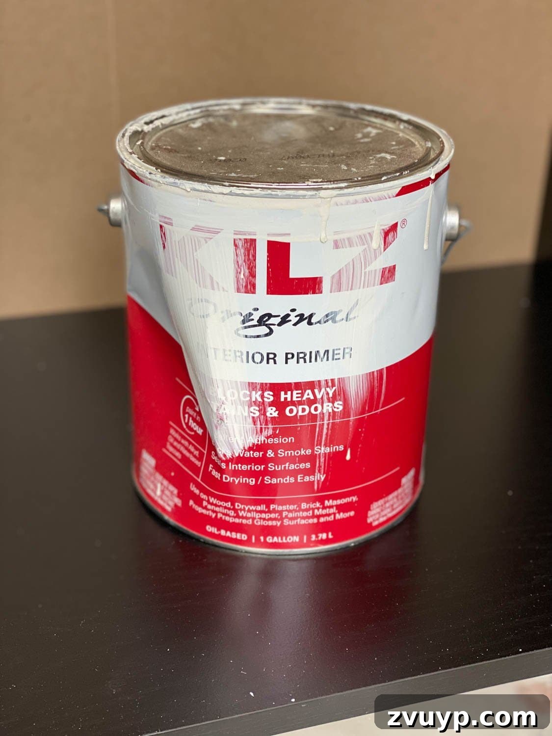 Regan's Room Transformation Painting Laminate Furniture 6 Applying an even coat of oil-based primer to laminate furniture, a crucial step for durable paint adhesion.