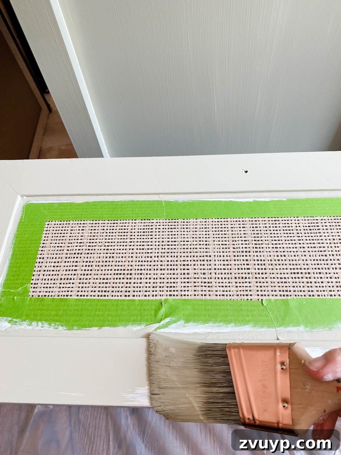 Regan's Room Transformation Painting Laminate Furniture 8 Applying acrylic paint over a primed laminate dresser, showcasing the transformation of the furniture piece.
