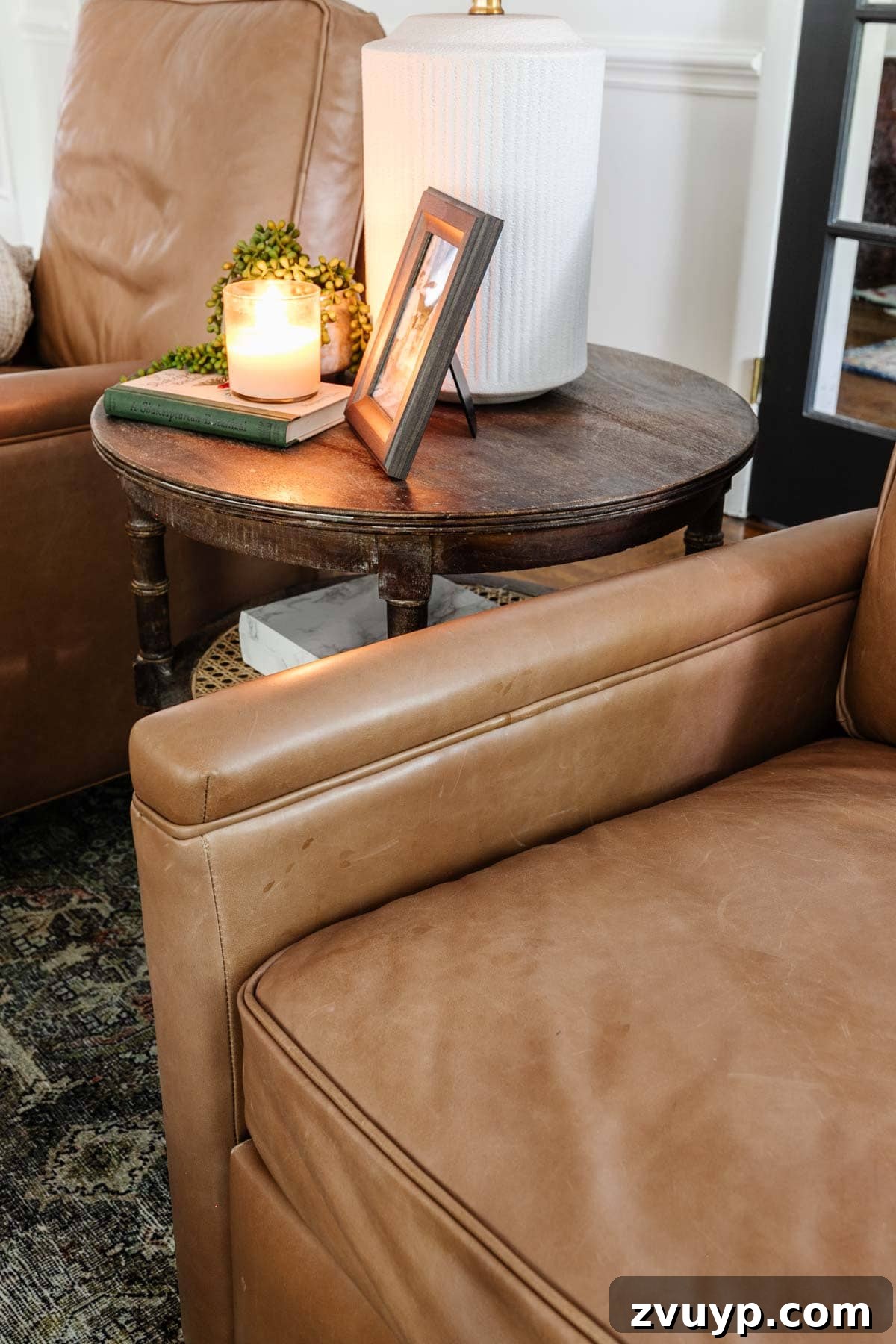 Close-up of leather patina and wear on a Pottery Barn Tyler recliner, showing its aged character