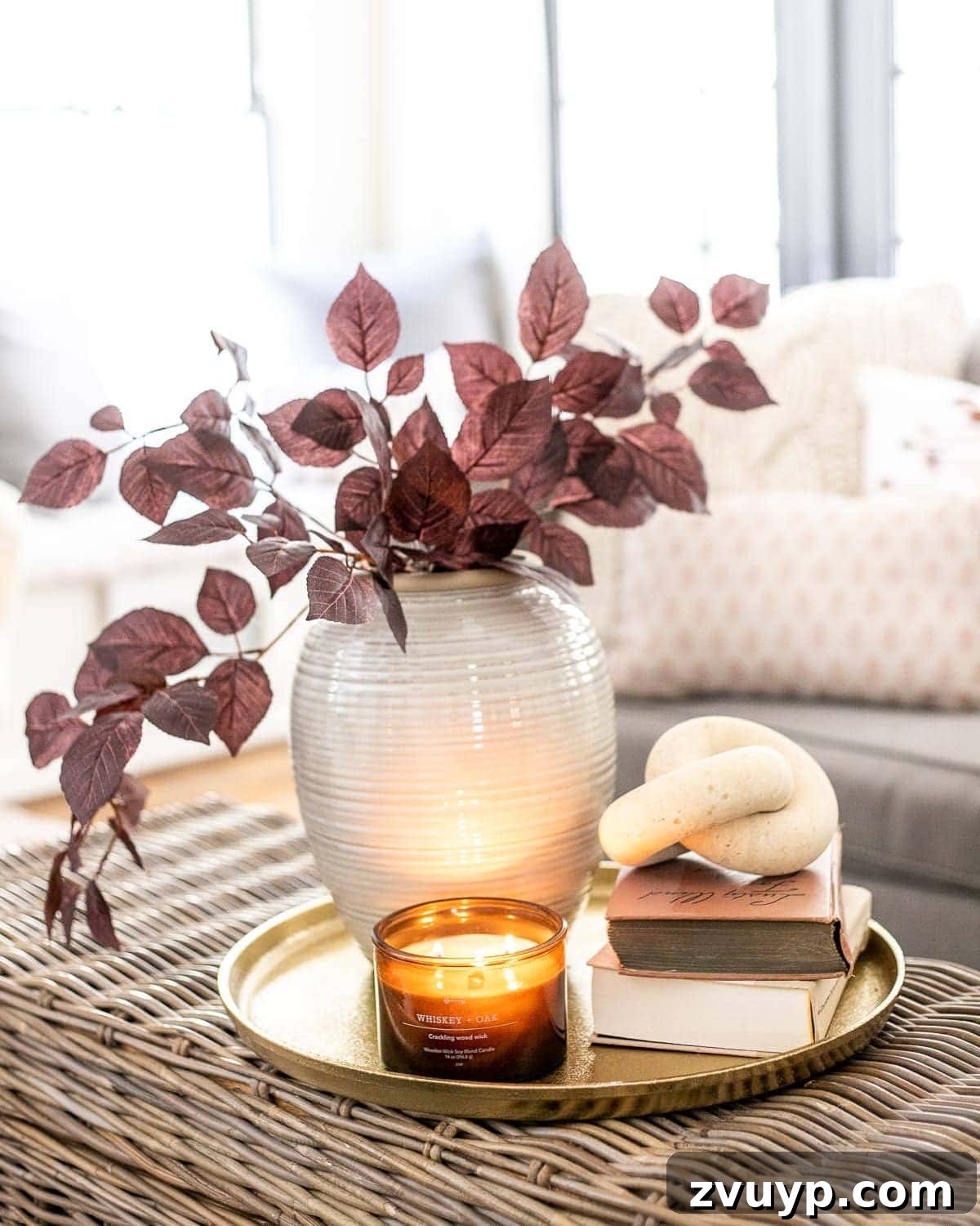 Top Fall Decor Picks Under 40 Dollars 2 fall decor on a coffee table with brass tray, amber glass candle, wood knot, books, and vase with autumn stems