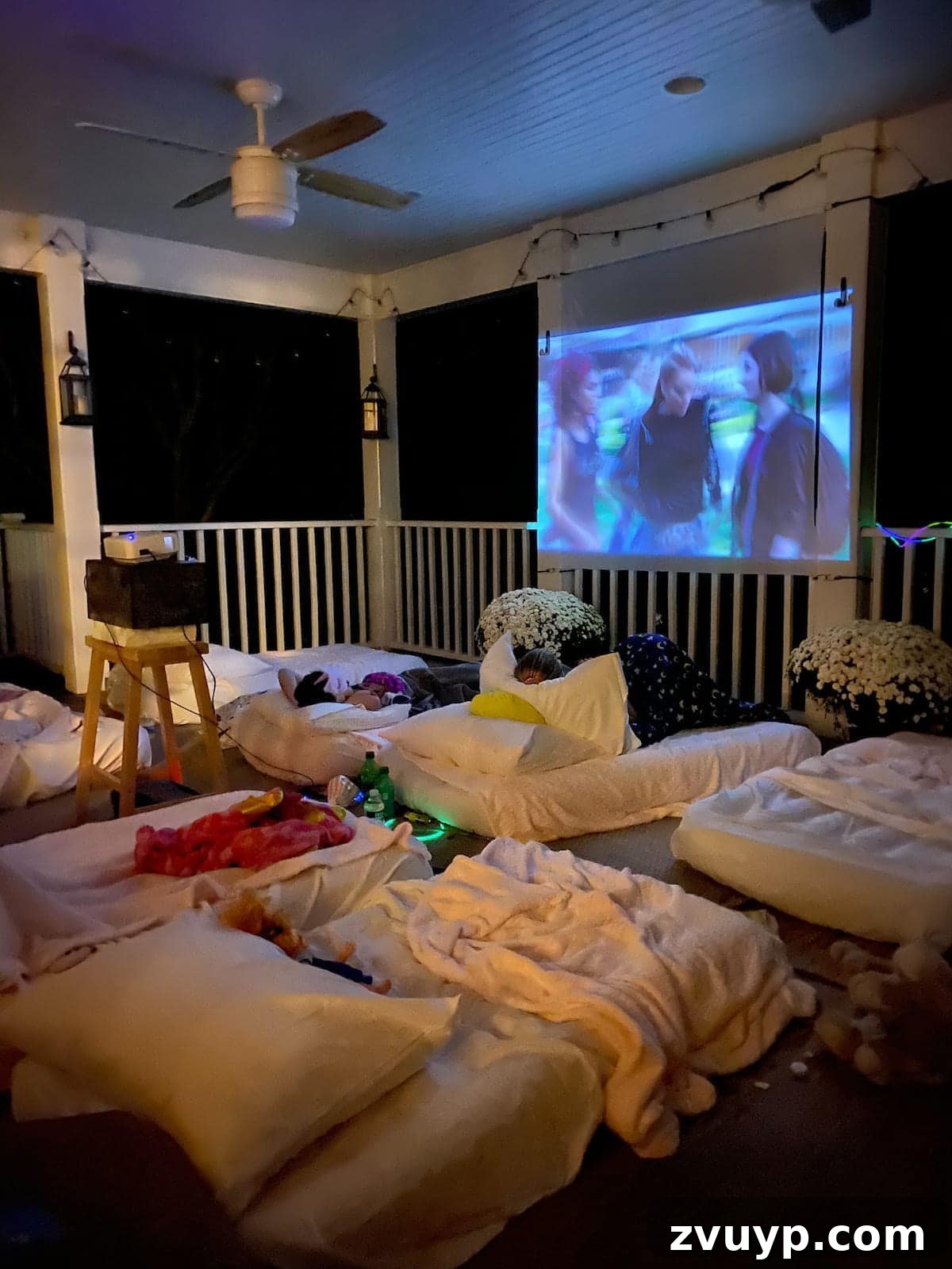 Create an Epic Backyard Movie Night Without Breaking the Bank 15 outside movie night set up on a back porch for a birthday sleepover party