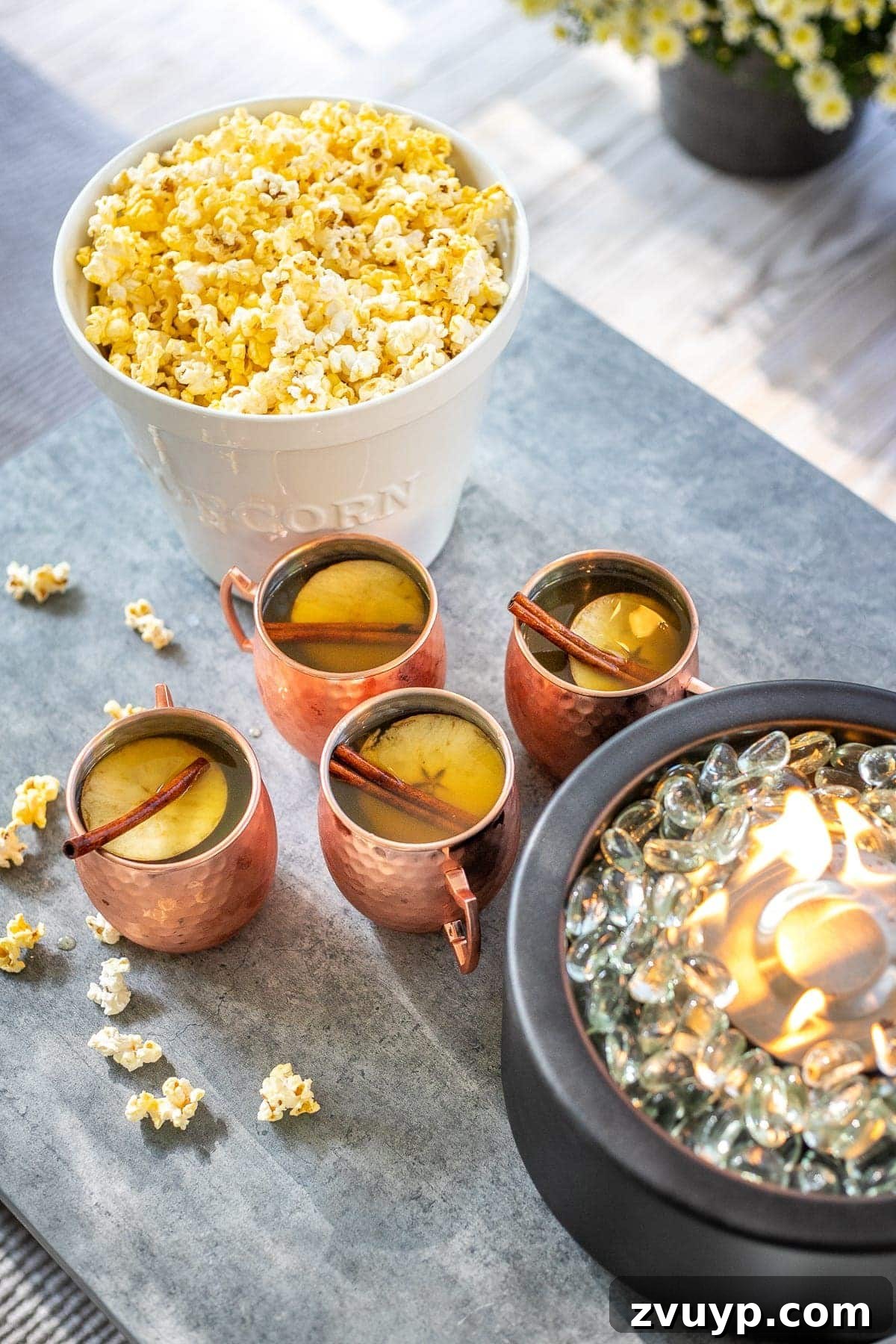 Create an Epic Backyard Movie Night Without Breaking the Bank 18 bucket of popcorn and copper mugs of apple cider