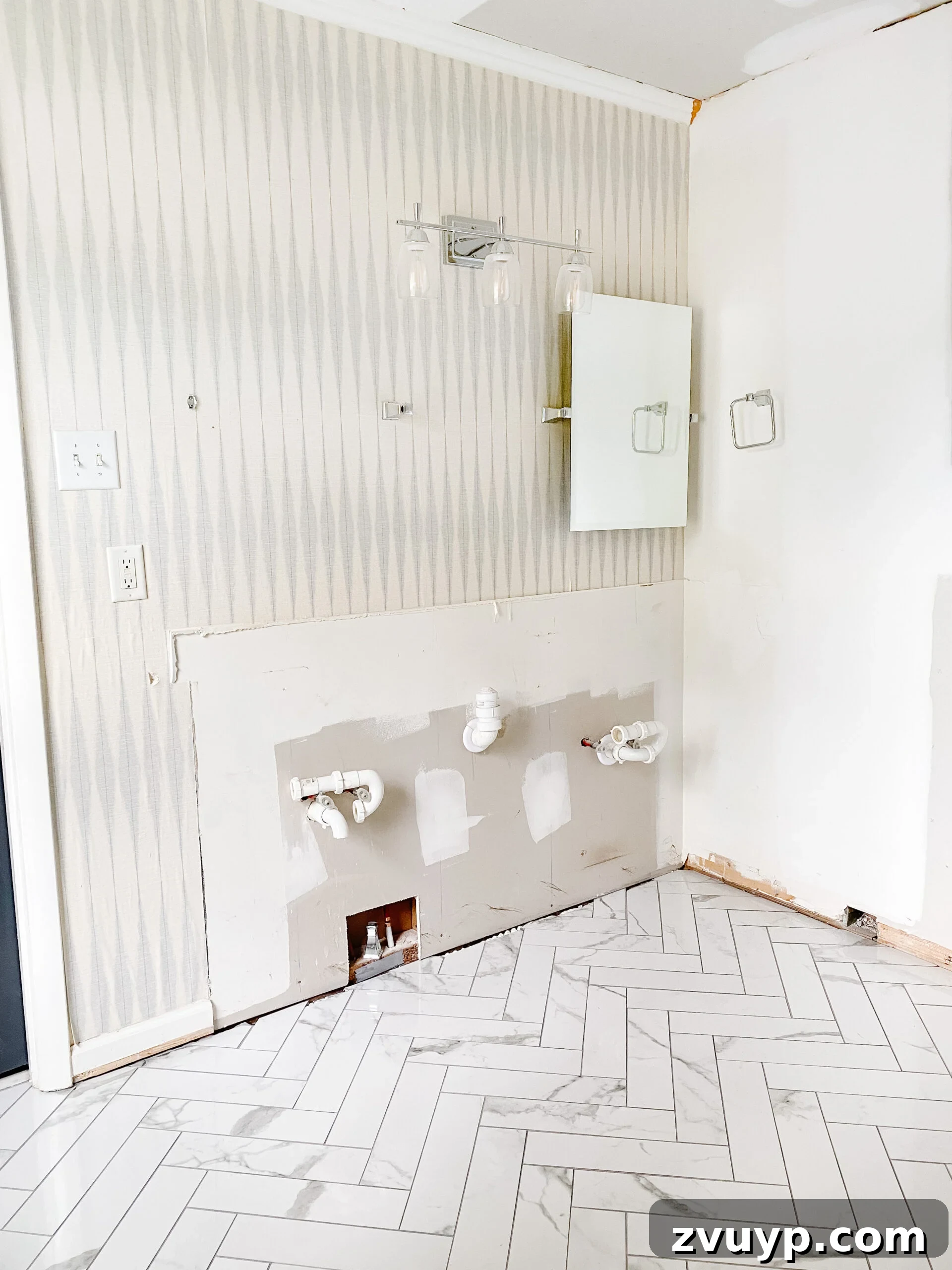 Faux Marble Herringbone: Our Shower Transformation Unfolds 11 A wide shot of the bathroom renovation, highlighting the new faux marble herringbone tile floor and the ongoing transformation.