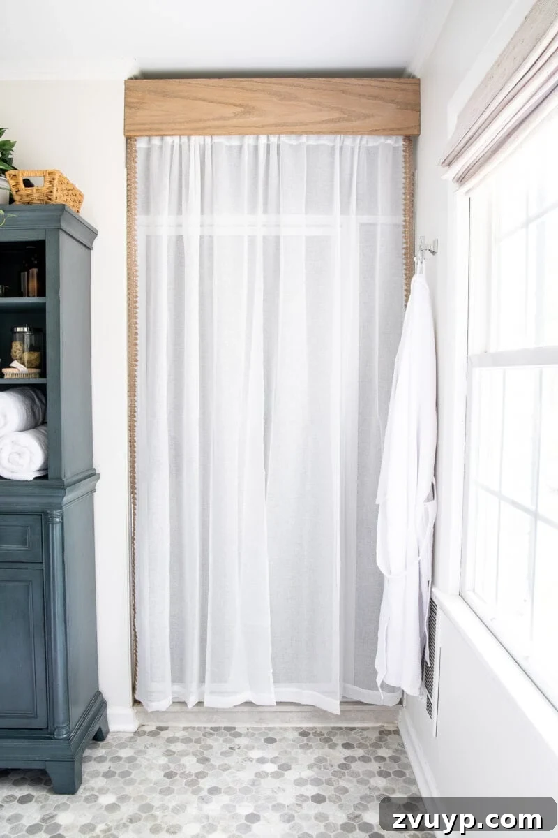 Faux Marble Herringbone: Our Shower Transformation Unfolds 3 Refreshed bathroom with a curtain concealing the old shower door and updated decor.