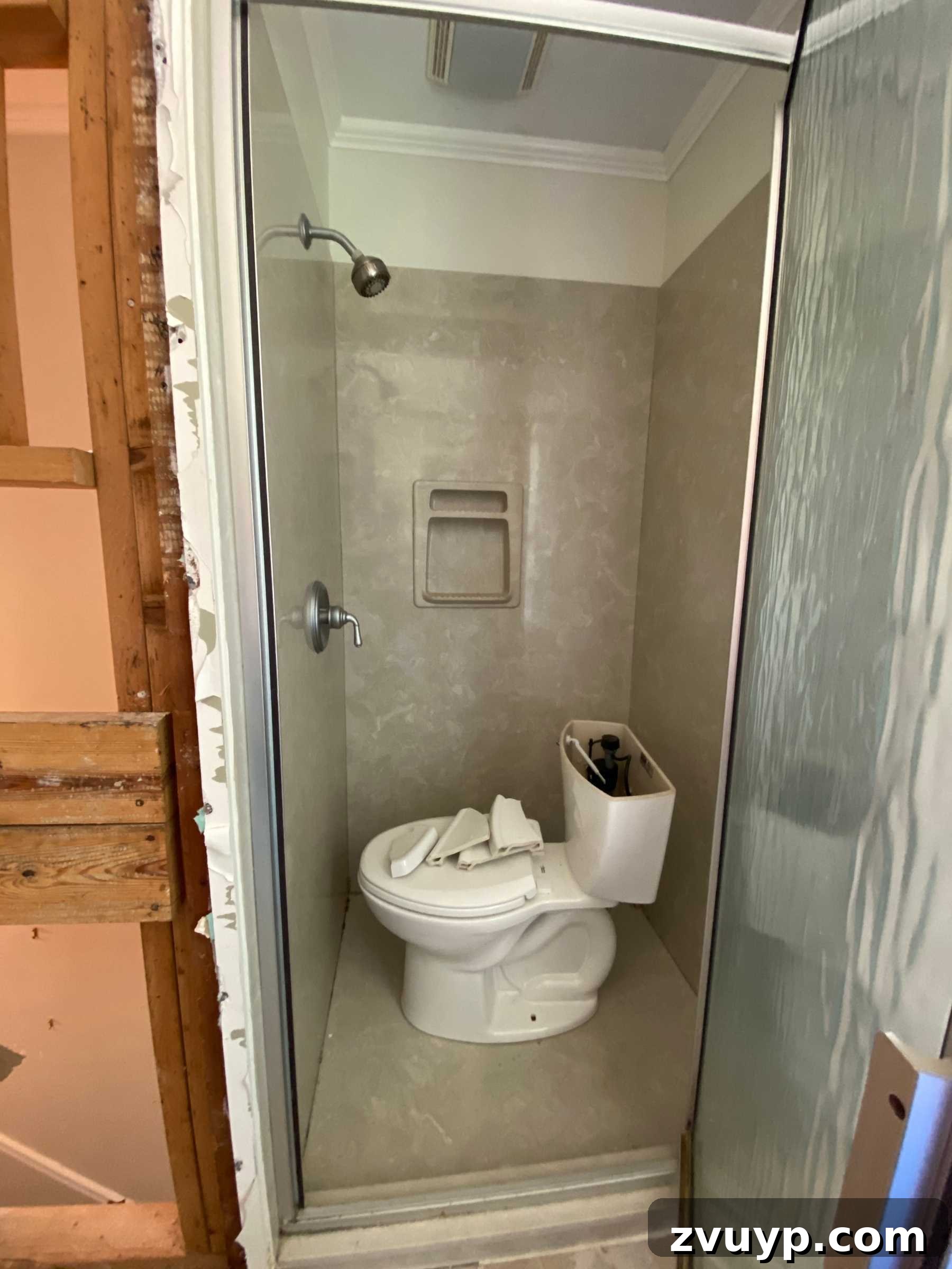 Faux Marble Herringbone: Our Shower Transformation Unfolds 4 Close-up of the outdated 80s beige shower surround before renovation.