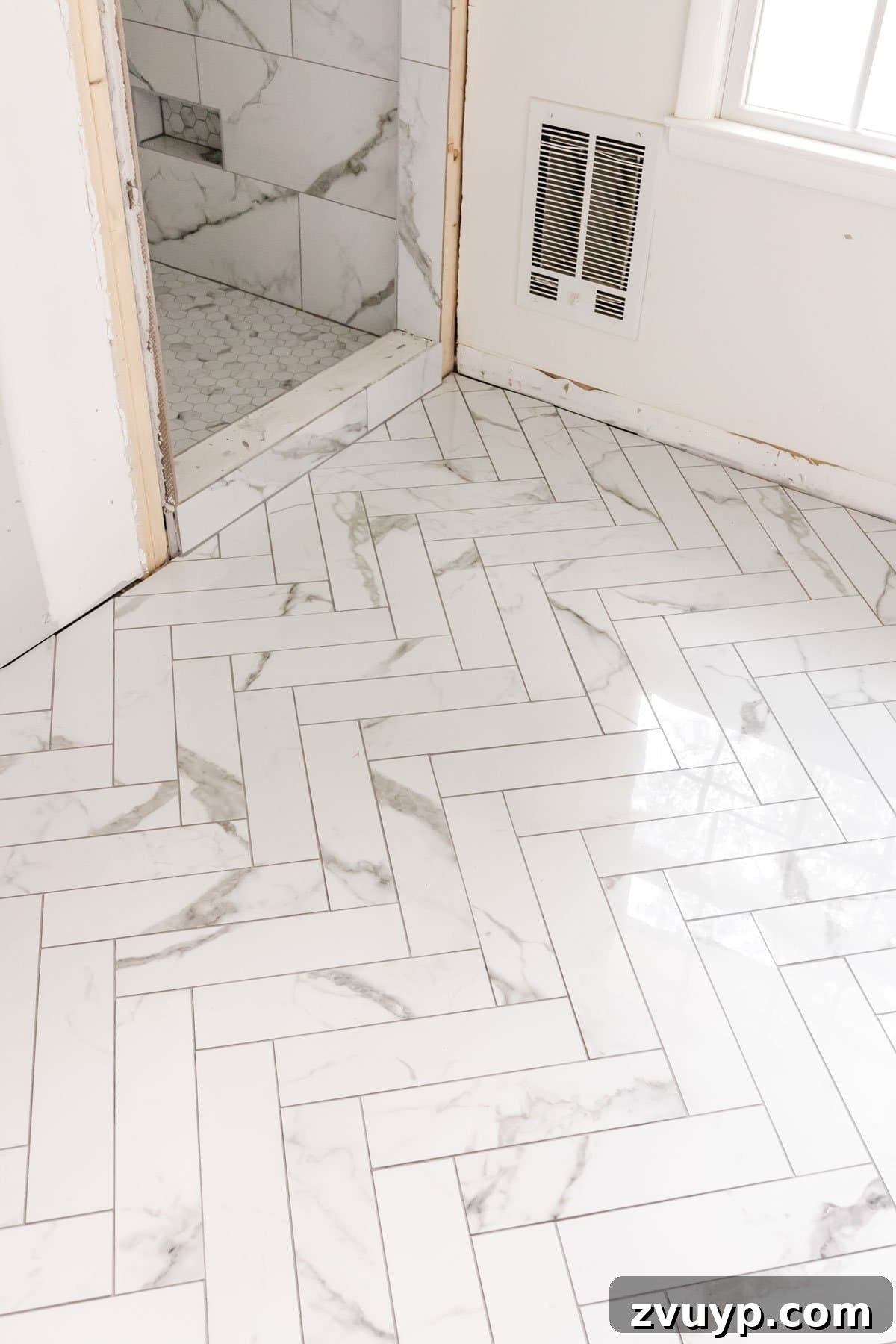 Faux Marble Herringbone: Our Shower Transformation Unfolds 7 Close-up of the exquisite faux marble herringbone tile floor, highlighting the intricate pattern and realistic veining.