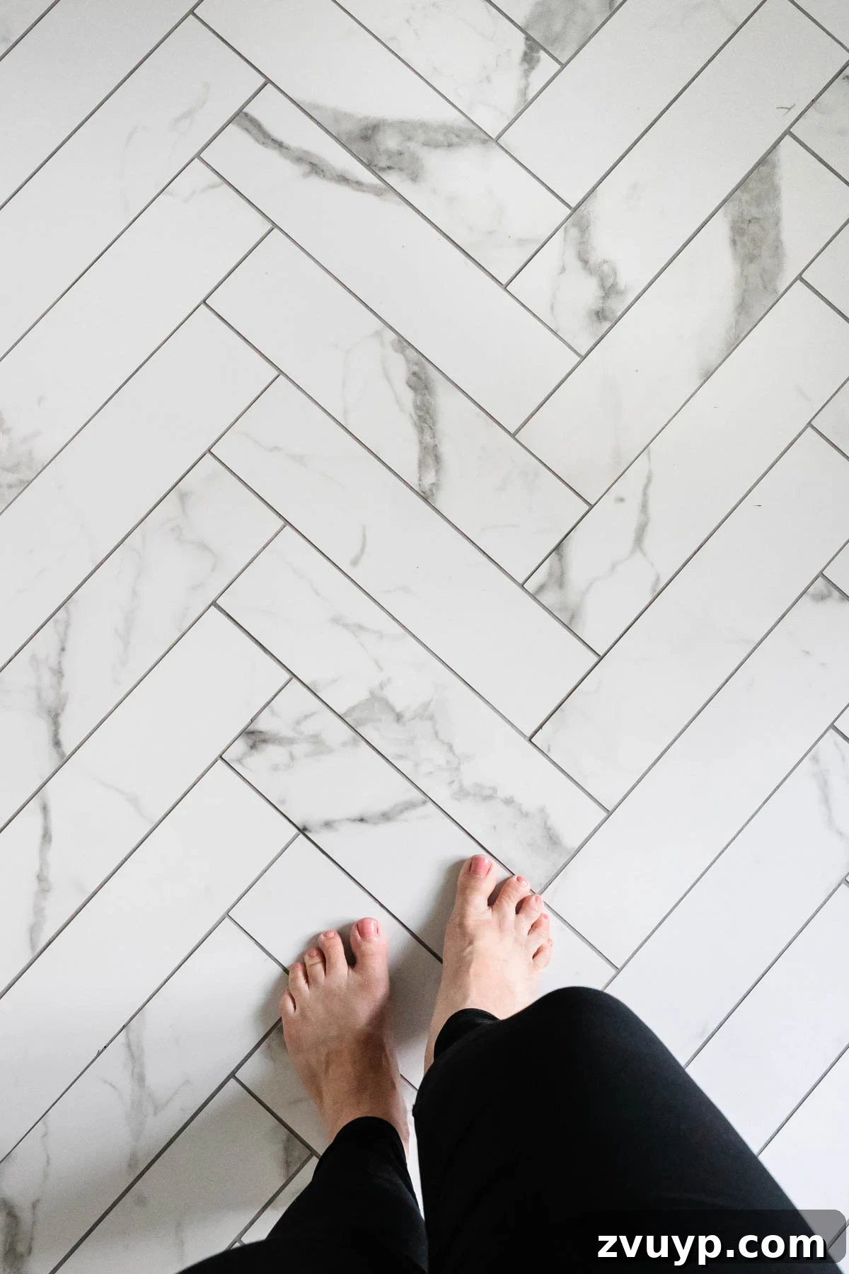 Faux Marble Herringbone: Our Shower Transformation Unfolds 8 Detailed view of the faux marble herringbone tile floor with precisely applied gray grout.
