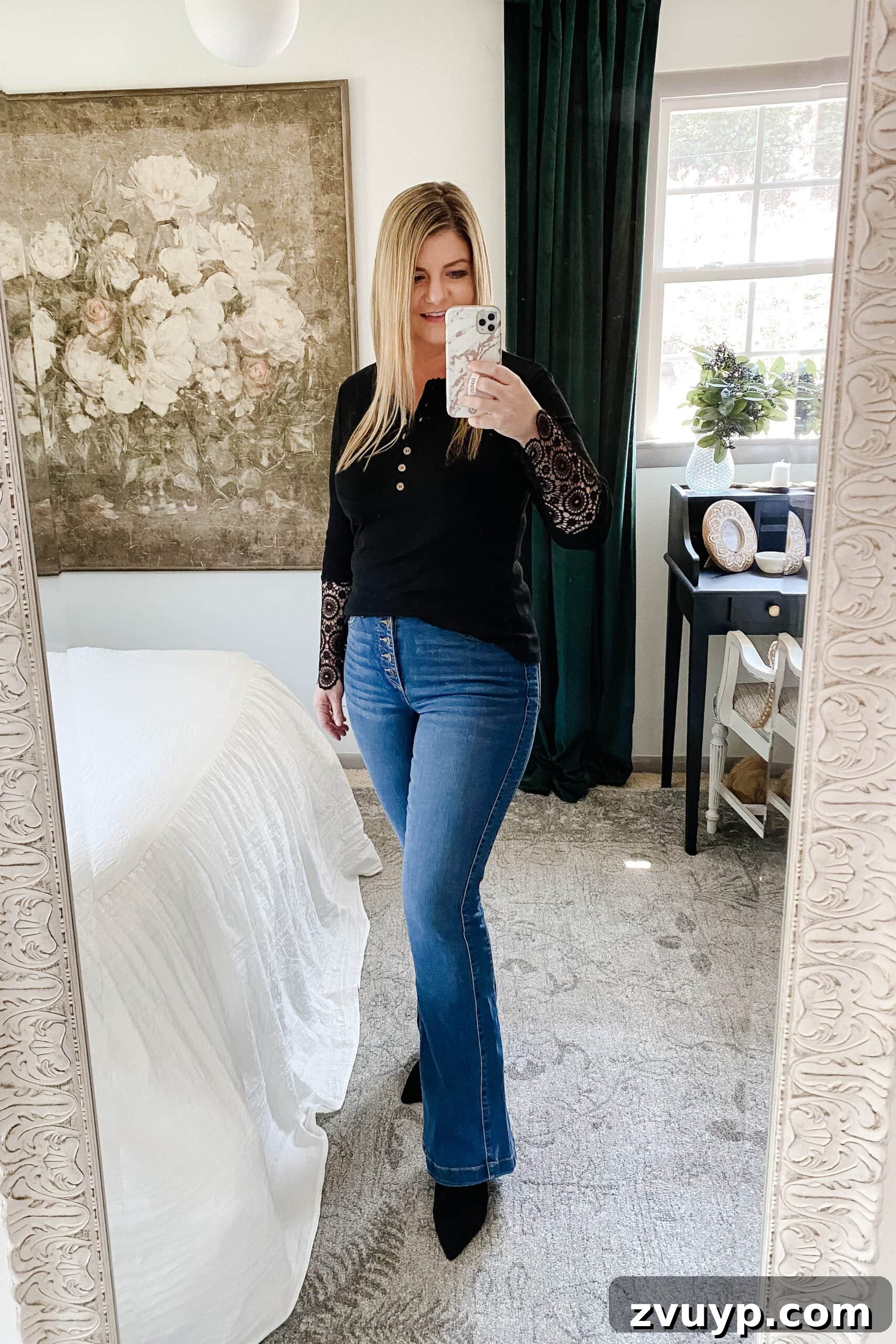 Unlock a Slimmer You: 6 Fall Outfits for Effortless Style 5 Slimming fall outfit idea: dark front tucked top, flare jeans, pointed toe boots
