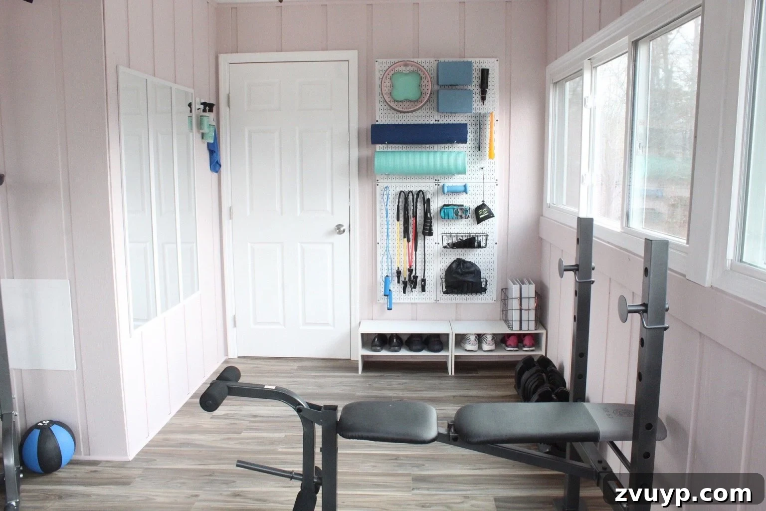 Transform Your Space: Home Gym Ideas for Basements, Garages, and Sheds 9 Workout room featuring a wall-mounted pegboard organizer for small workout equipment