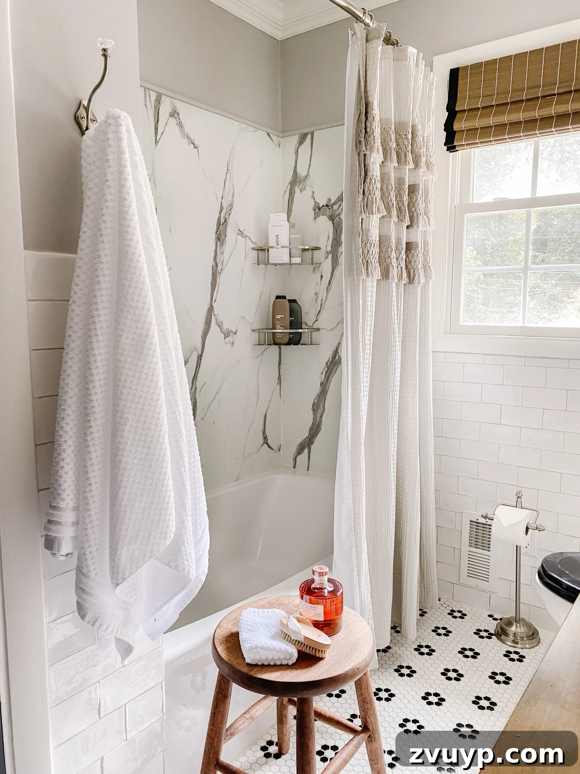 High-Contrast Haven: Black and White Bathroom Updates 15 marble shower with black and white retro tile and gray shower curtain