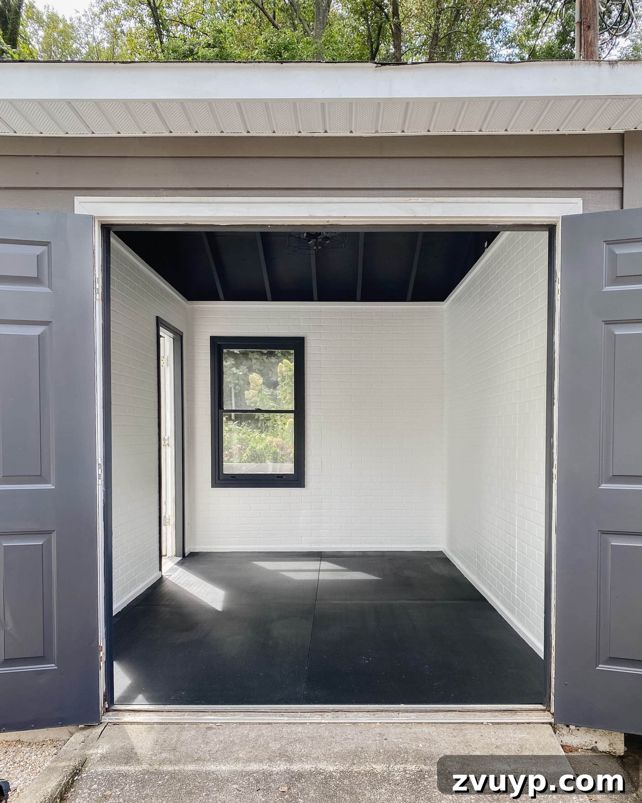Transform Your Gym Shed with DIY Faux Brick Walls 2 Finished gym shed featuring modern industrial white faux brick walls, a sleek black ceiling, and organized workout equipment, showcasing a dramatic transformation.