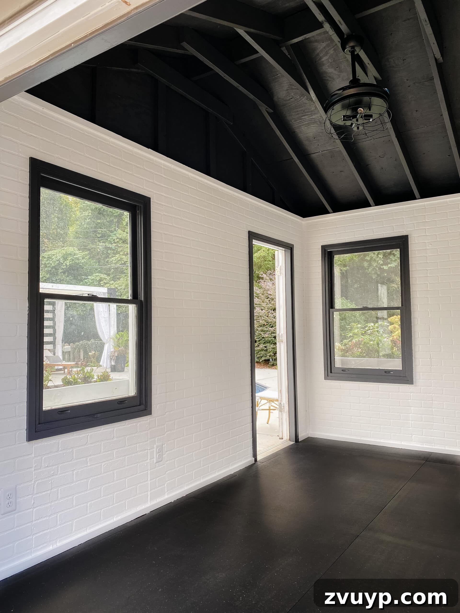 Crafting Your Dream Home Gym, One Budget-Friendly Piece at a Time 2 empty home gym shed with white brick and black ceiling