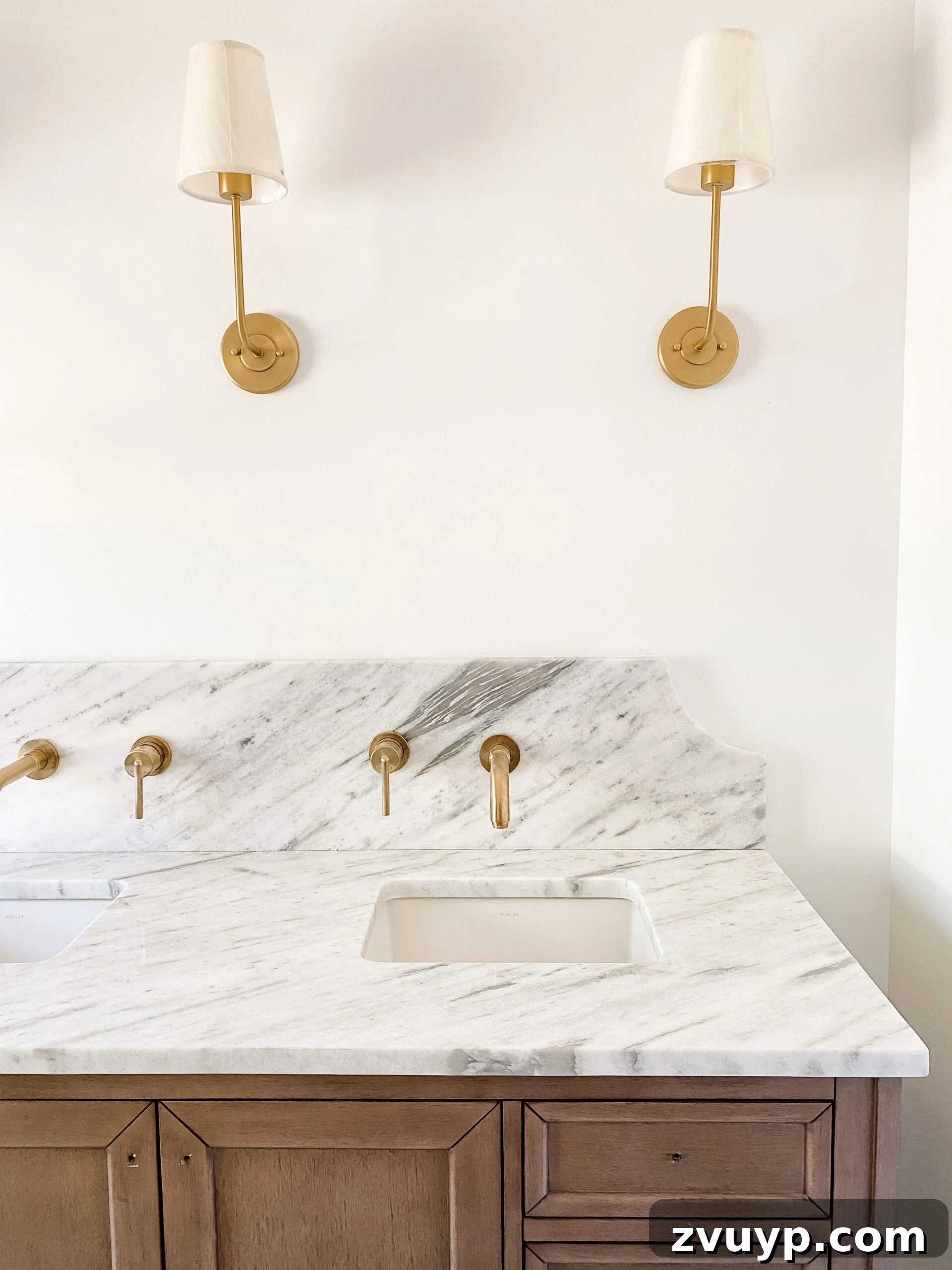 Our En Suite Bathroom Remodel: Faucets Are Finally In! 3 scalloped marble backsplash with gold wall mount faucets in en suite bathroom