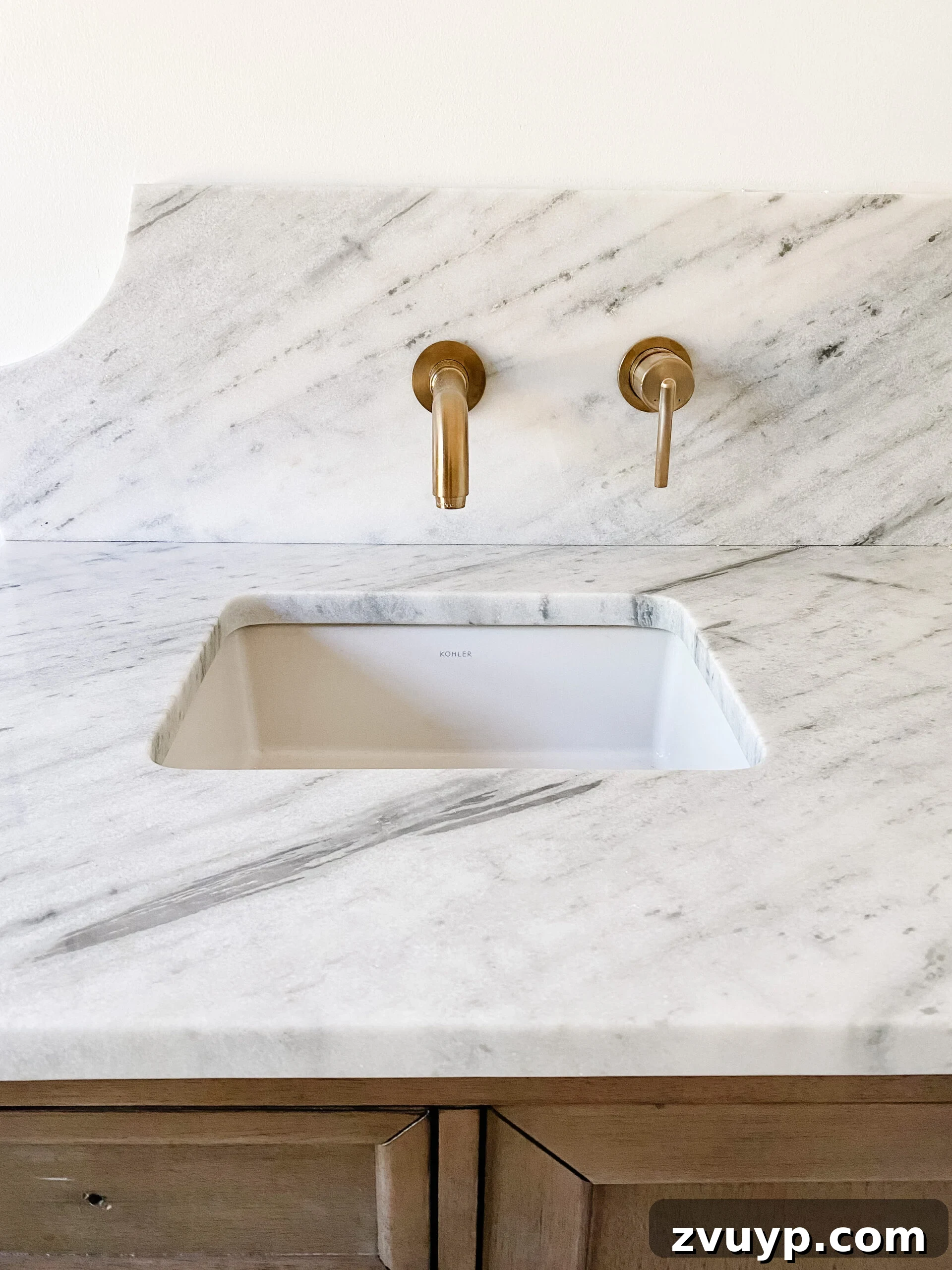 Our En Suite Bathroom Remodel: Faucets Are Finally In! 4 scalloped marble backsplash with gold wall mount faucets in en suite bathroom