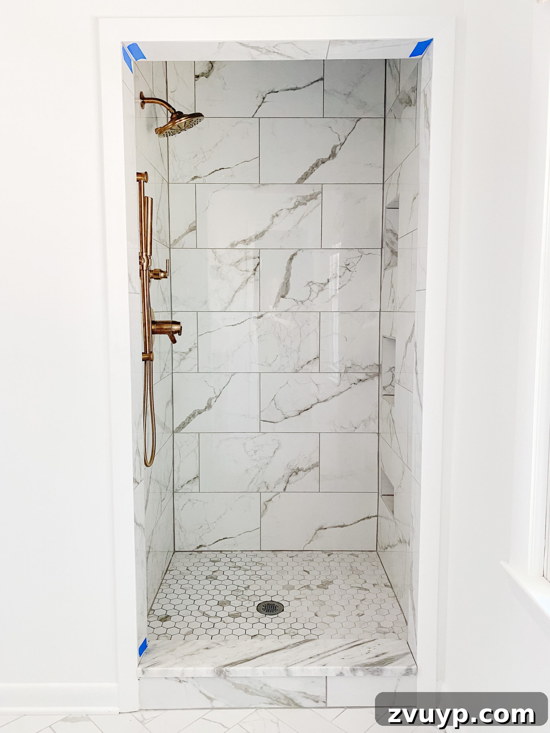 Our En Suite Bathroom Remodel: Faucets Are Finally In! 8 faux marble porcelain tile shower with gold shower faucets
