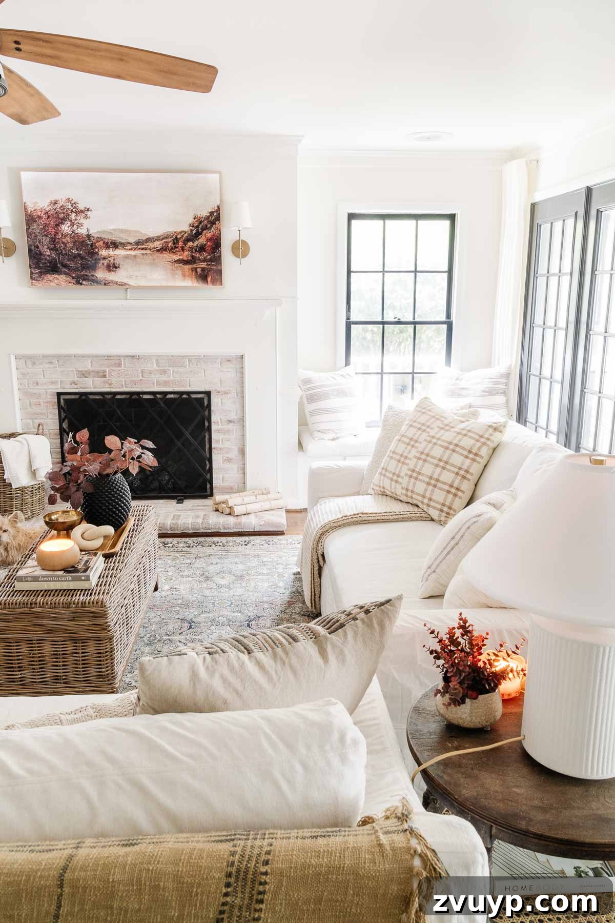 white slipcovered slope arm york pottery barn sofa with fall decor in living room
