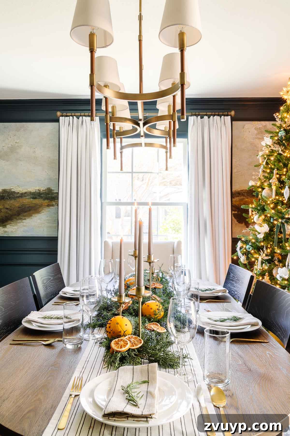 Elegant Christmas Tablescapes for Less 9 Striking simple Christmas centerpiece featuring vibrant orange pomanders and fresh-cut evergreen branches, exuding natural charm and holiday spirit