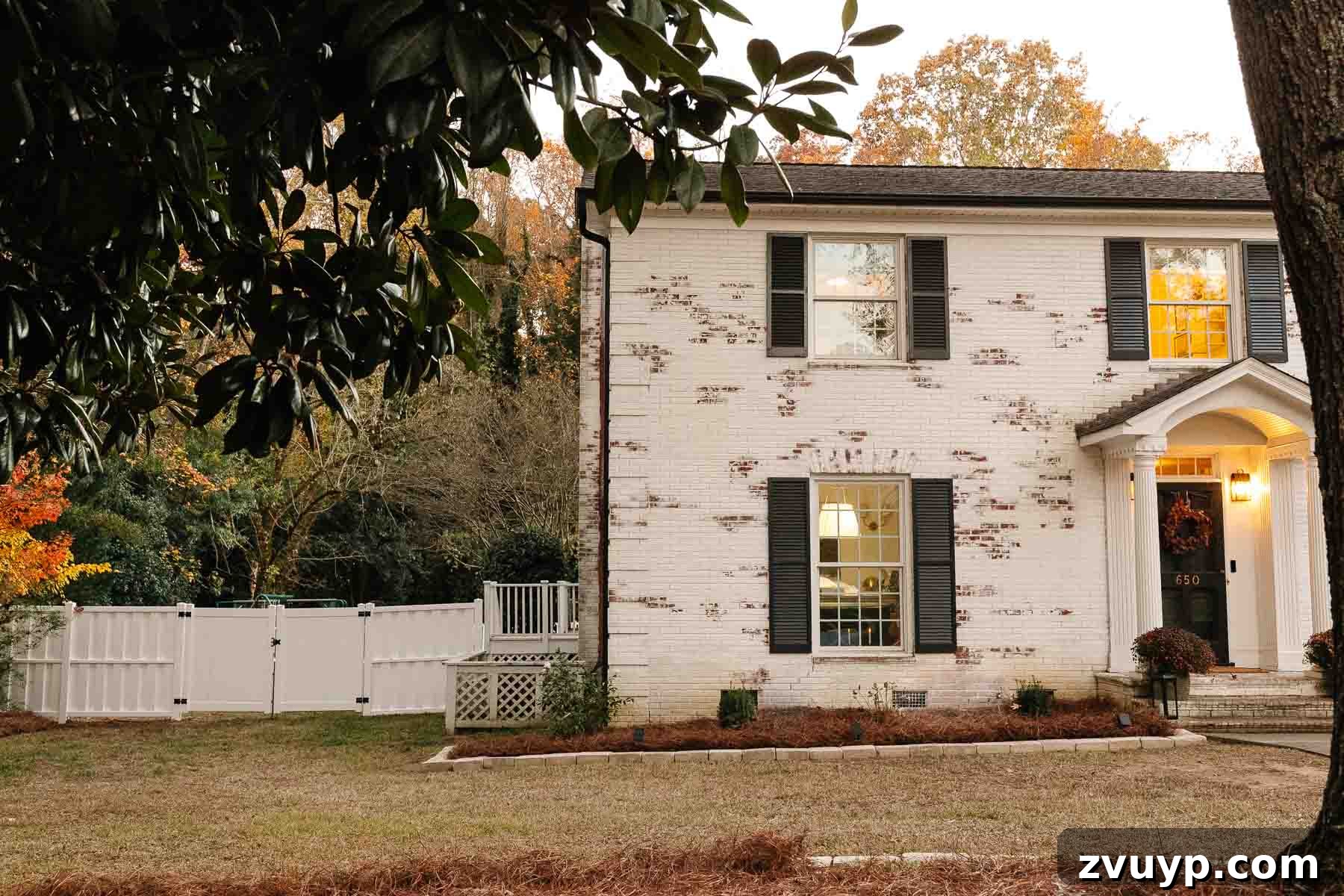 Vinyl Fence Installation Made Easy: Your Ultimate Guide 14 white limewashed brick colonial house with backyard fence