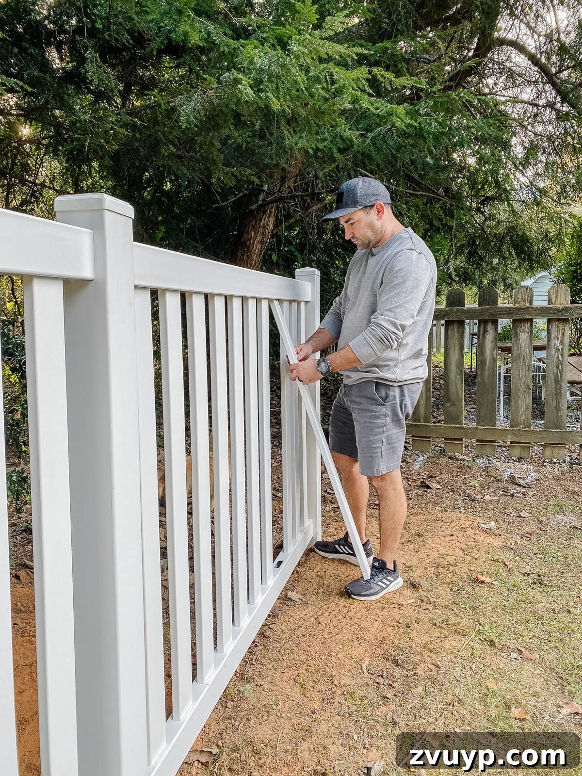 Vinyl Fence Installation Made Easy: Your Ultimate Guide 22 white vinyl fence installation using Ply Gem in a backyard