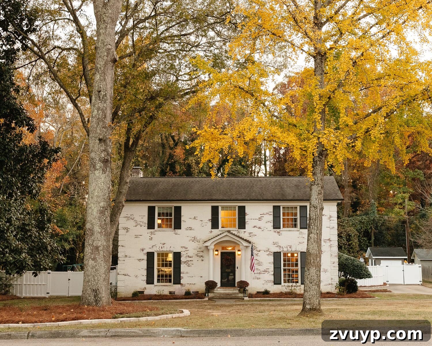 Vinyl Fence Installation Made Easy: Your Ultimate Guide 8 limewashed brick colonial house with fall trees