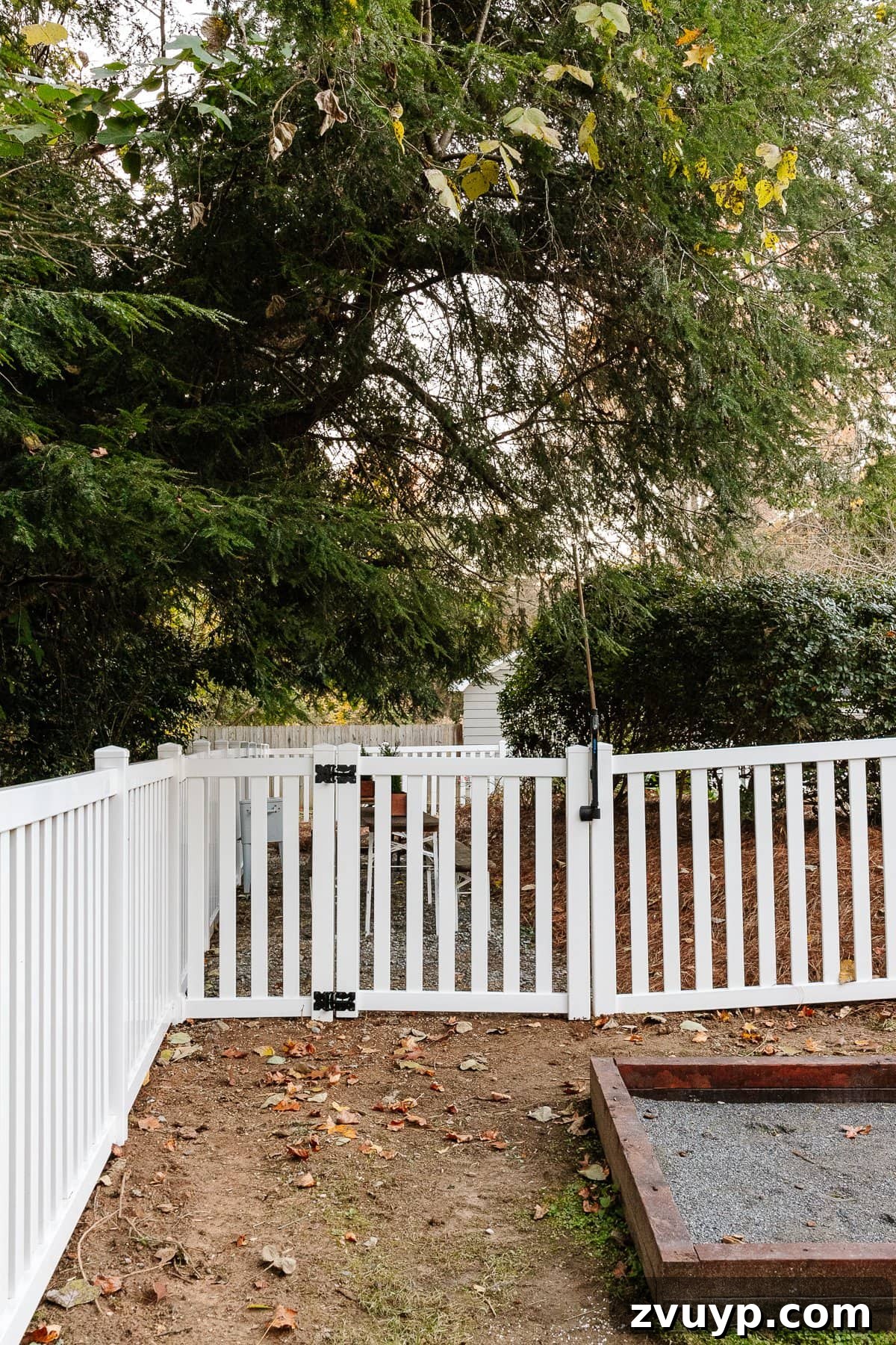 Vinyl Fence Installation Made Easy: Your Ultimate Guide 10 white vinyl fence with gate leading into backyard beer garden