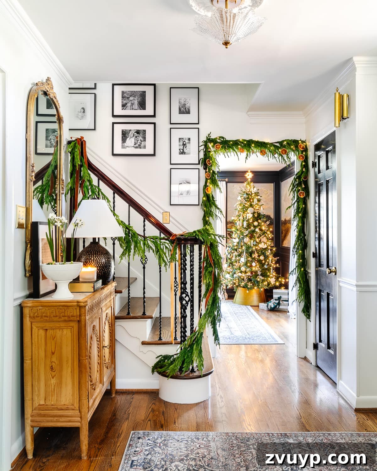 2021 Holiday Home Tour Classic Christmas Decor 2 Classic Christmas decor ideas in a foyer with realistic garland on stairs and doorway