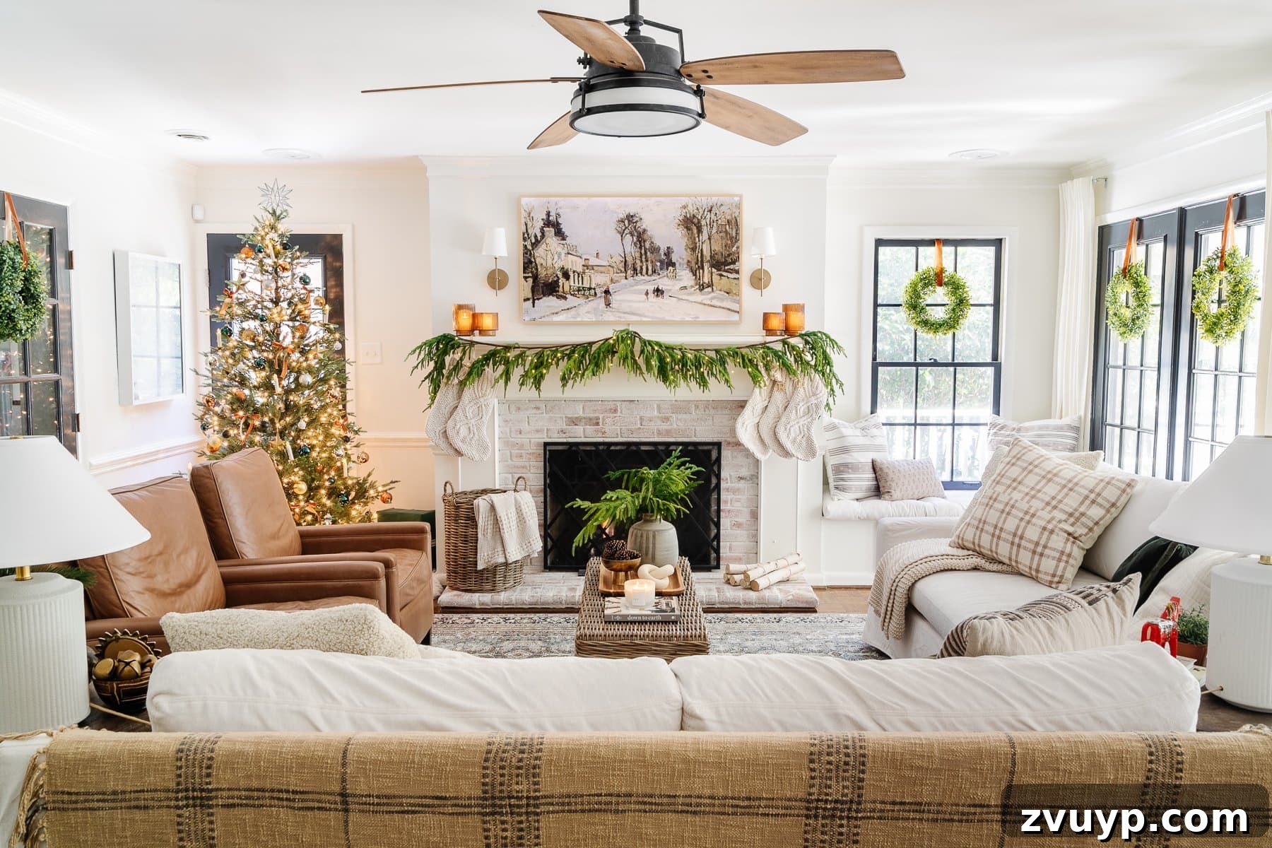 2021 Holiday Home Tour Classic Christmas Decor 24 neutral living room christmas with wreaths on windows and realistic garland