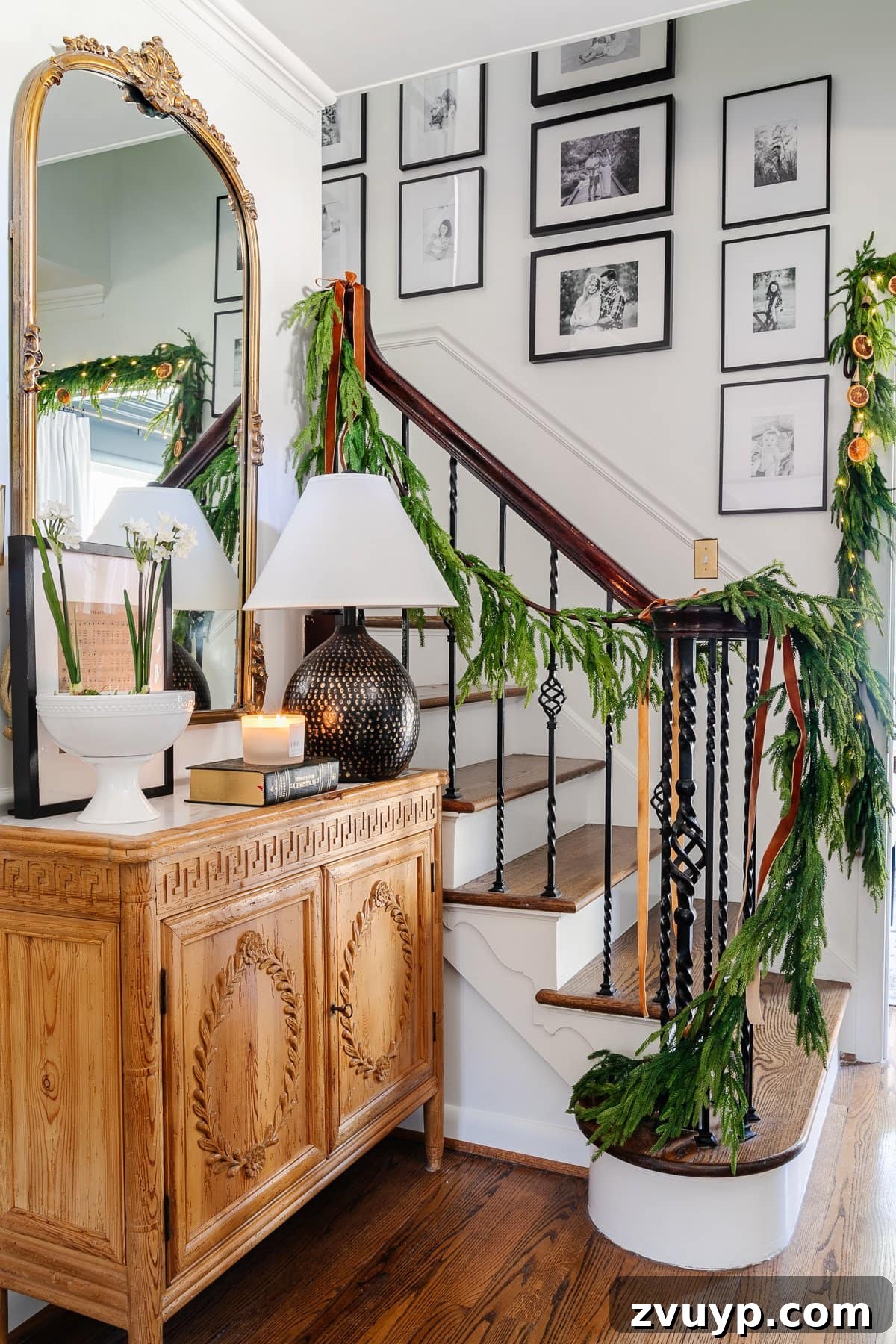 2021 Holiday Home Tour Classic Christmas Decor 7 realistic garland on stairs for Christmas decor in foyer