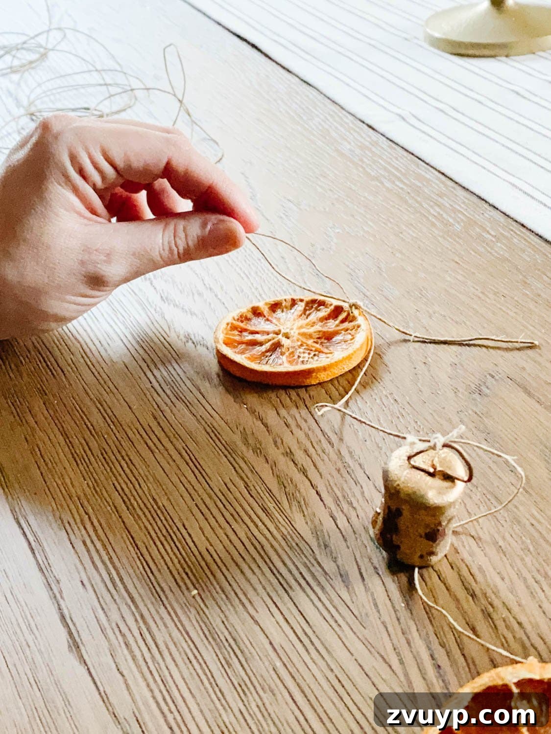 Effortless Homemade Dried Orange Garland 6 how to tie dried orange slices onto garland