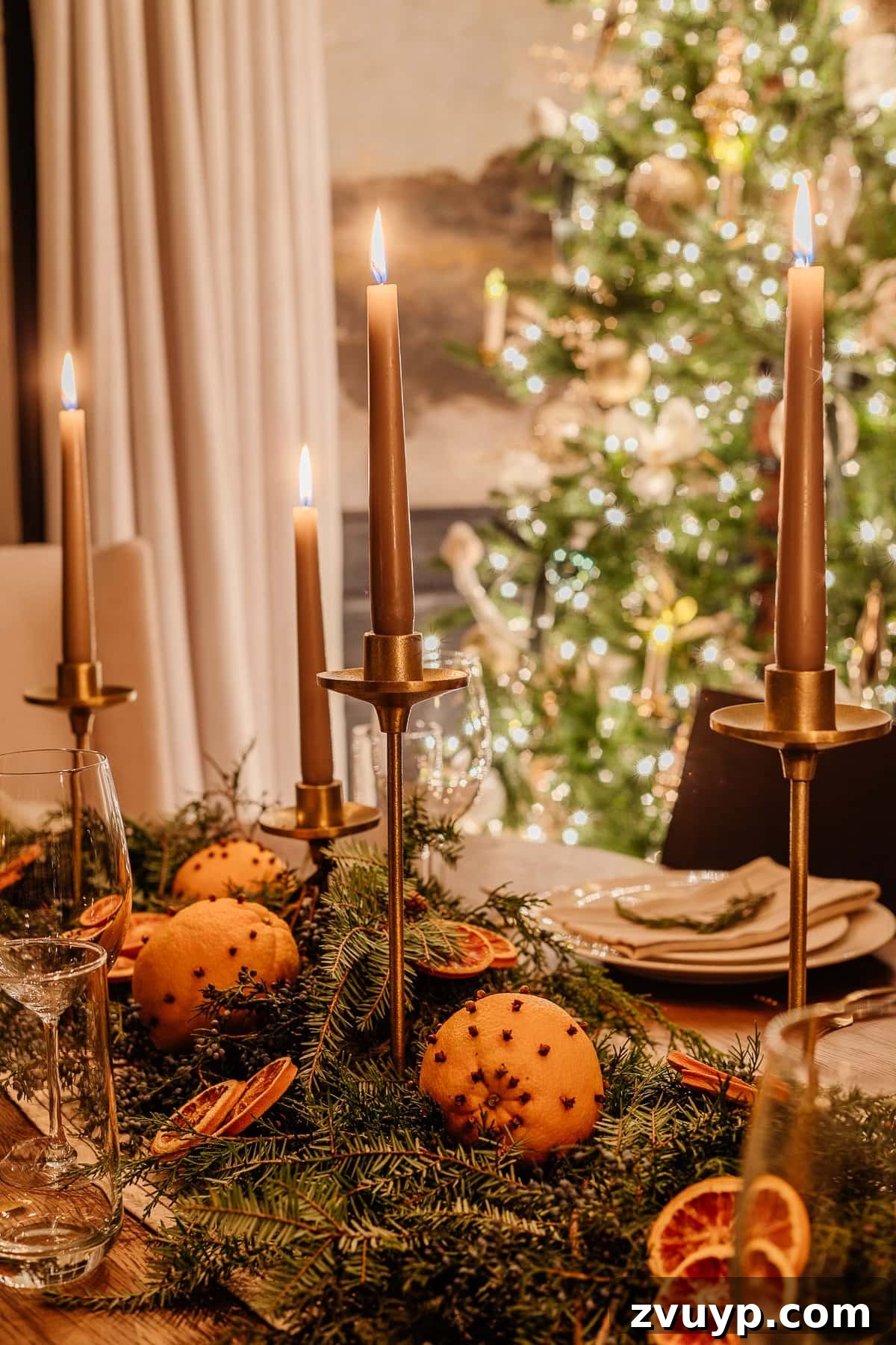Enchanted Glow Tour 11 A wider shot of the Christmas dining room table decor at night, showing more of the festive setting and the warm glow cast by candles, perfect for holiday entertaining.