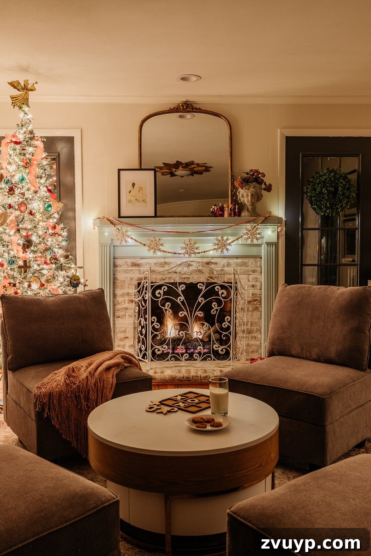 Enchanted Glow Tour 23 A cozy Christmas fireplace next to a sparkling Christmas tree in the playroom at night, creating a quintessential holiday scene that evokes warmth and cheer.