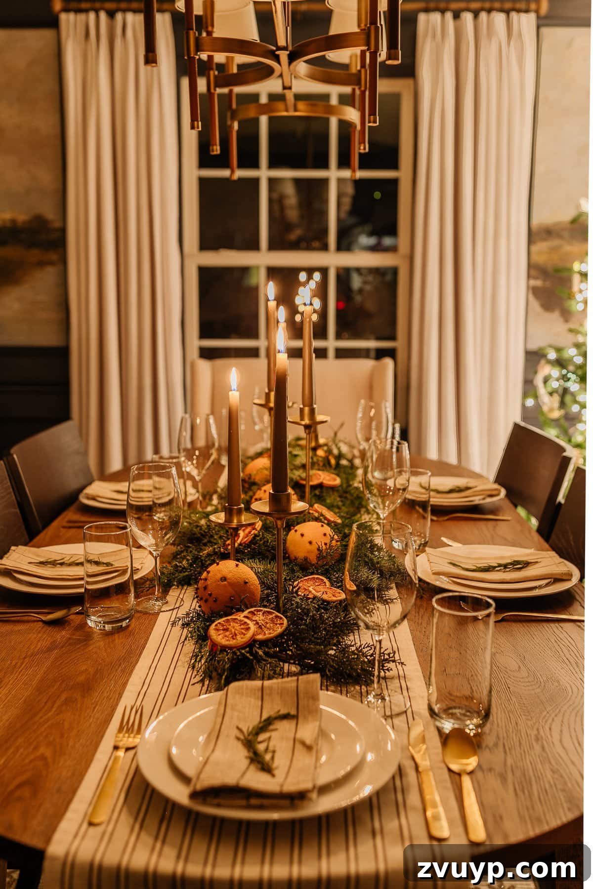 Enchanted Glow Tour 10 Christmas dining room table decor illuminated at night, featuring a festive centerpiece and place settings that shimmer under the soft candlelight, creating an inviting holiday atmosphere.
