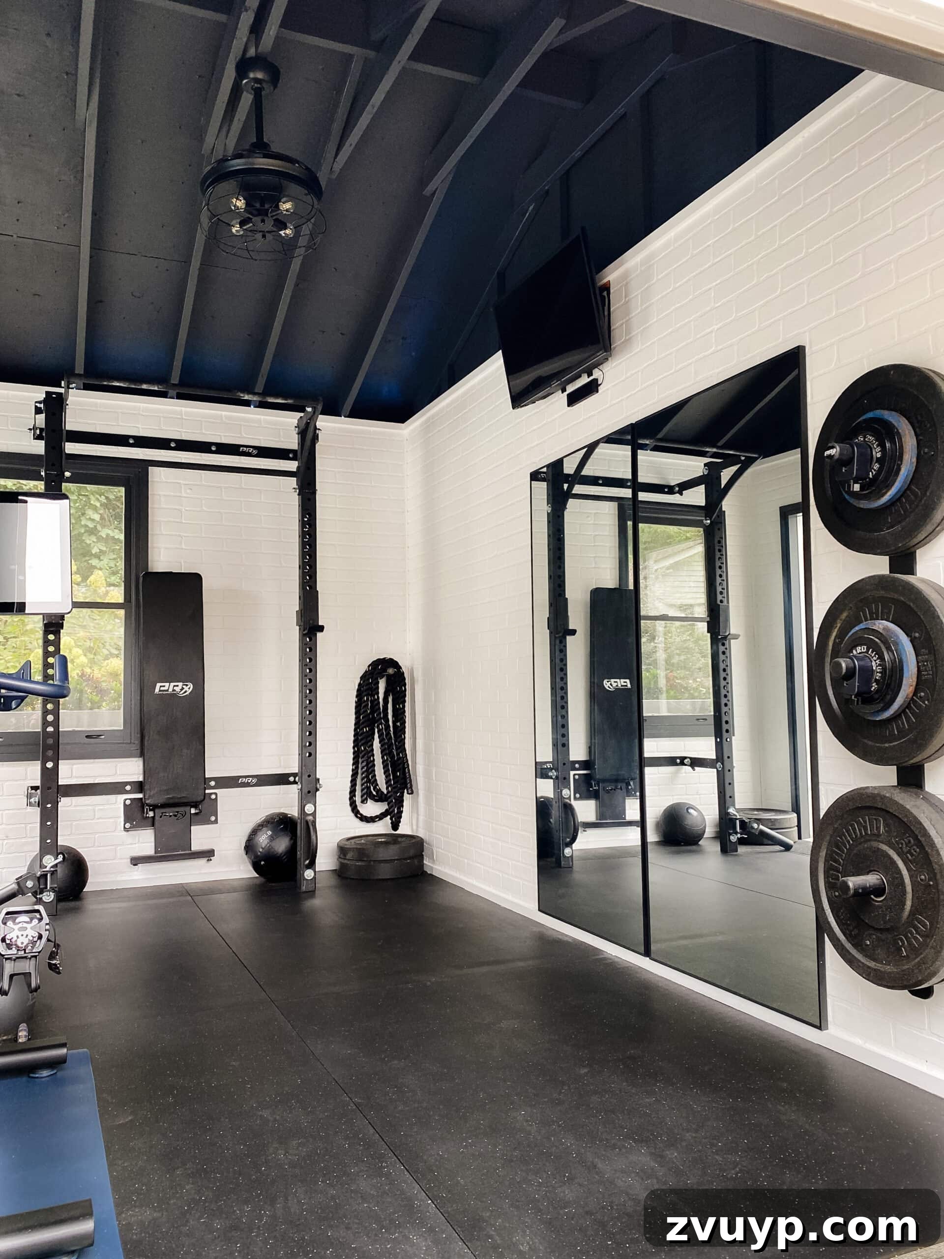 Your 2021 Product Champions 14 Large full-length wall mirror leaning against a wall in a home gym or entryway, reflecting light and making the space appear larger.