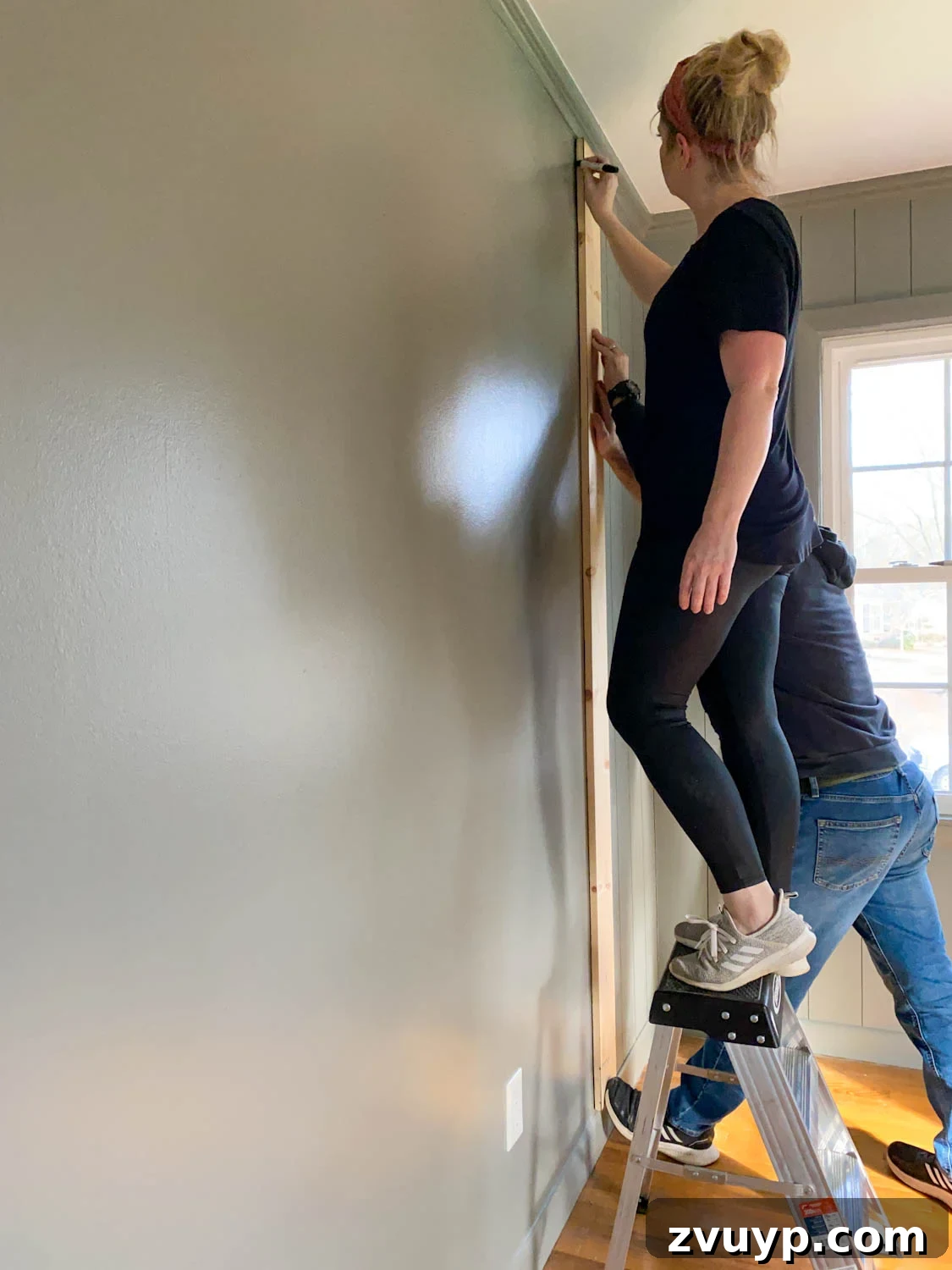 DIY Faux Wall Planks Whole Room Makeover for 20 Dollars 8 using 1x6 boards as spacers for tracing lines to mimic paneled walls with Sharpie paint pens