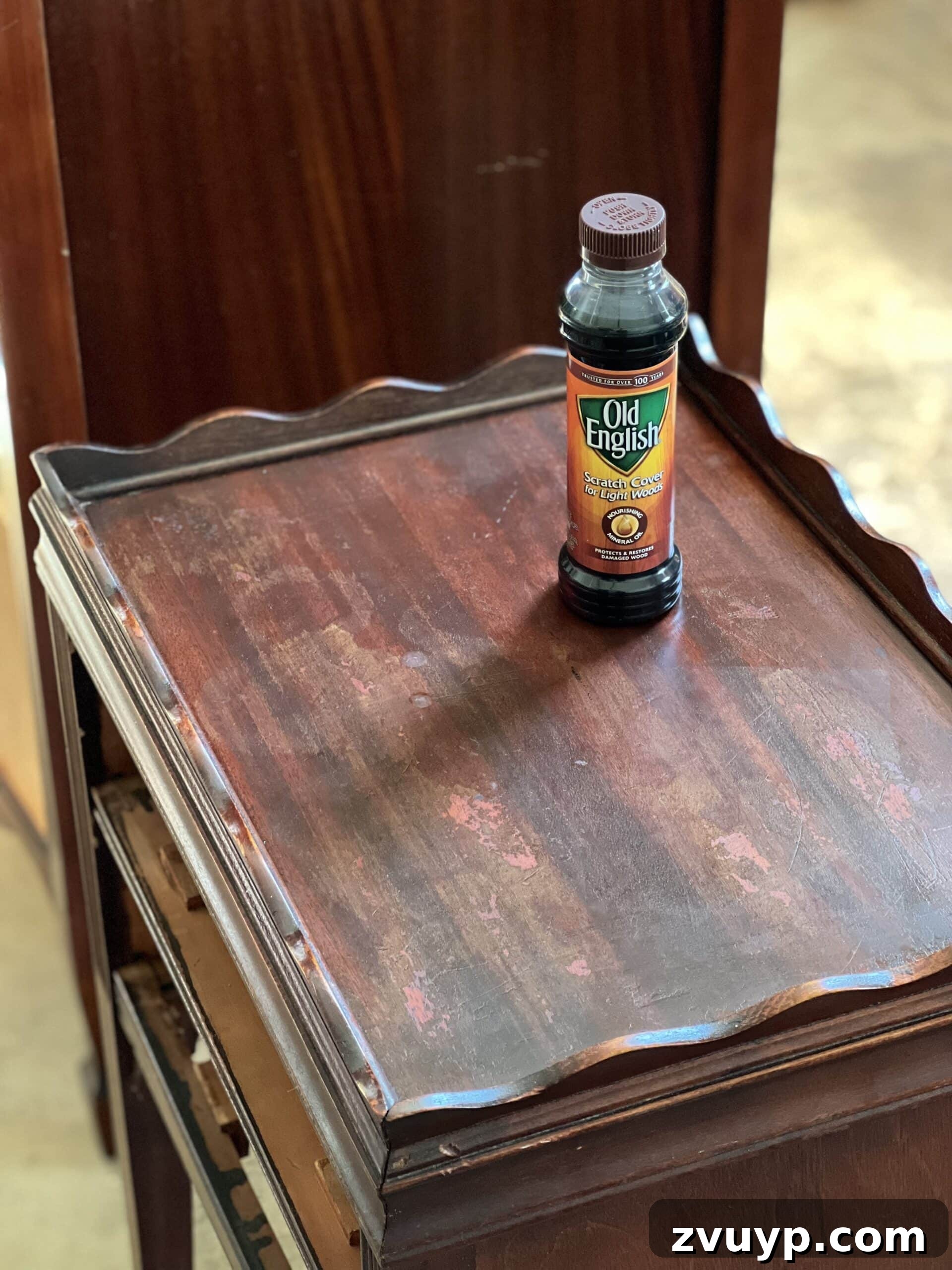Hand applying wood polish in circular motions on a wooden surface