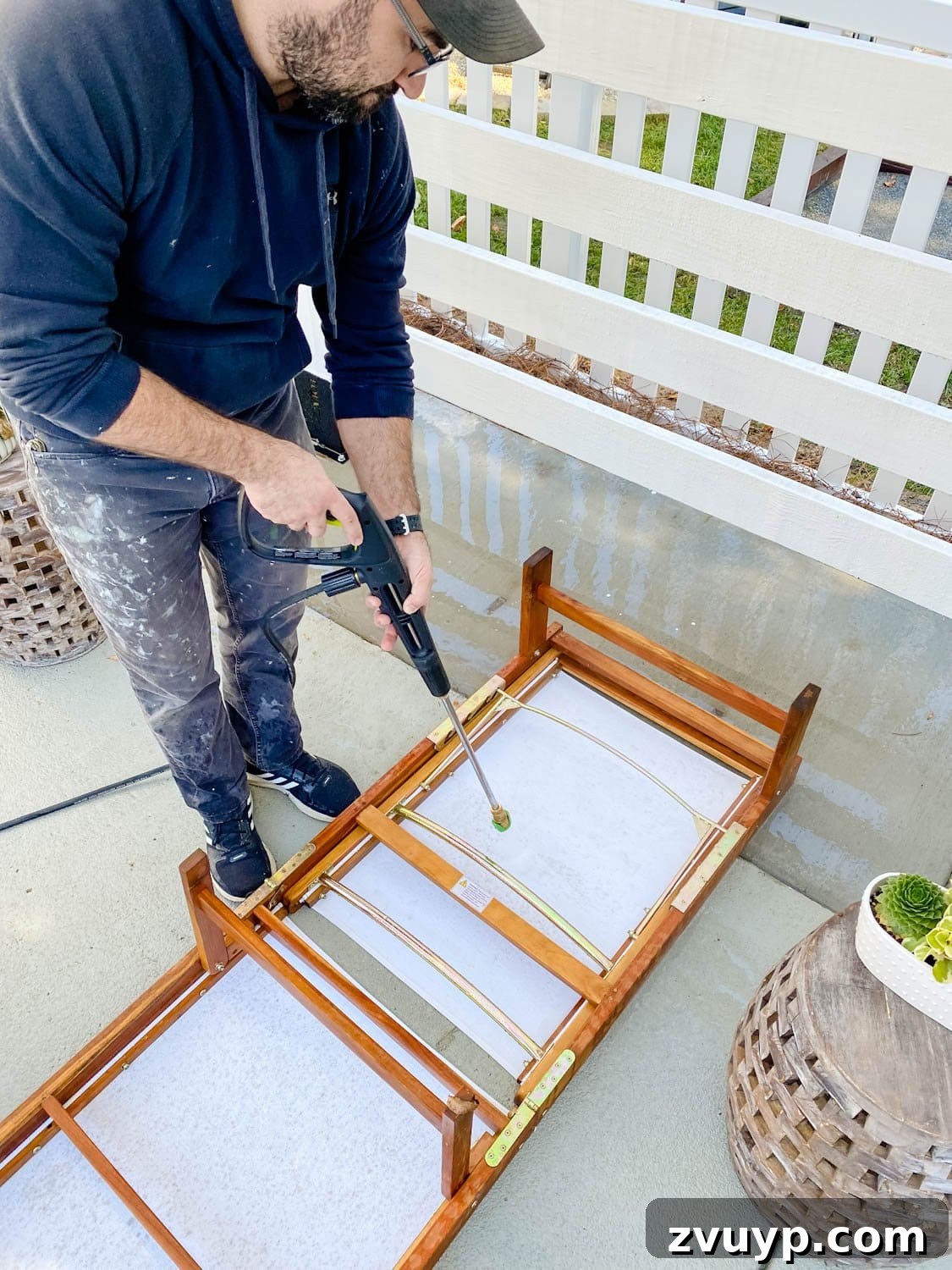 Revive Your Outdoor Oasis: Expert Cleaning for Cushions and Furniture 9 Thoroughly cleaning outdoor furniture with a power washer, ensuring all sides are spotless.