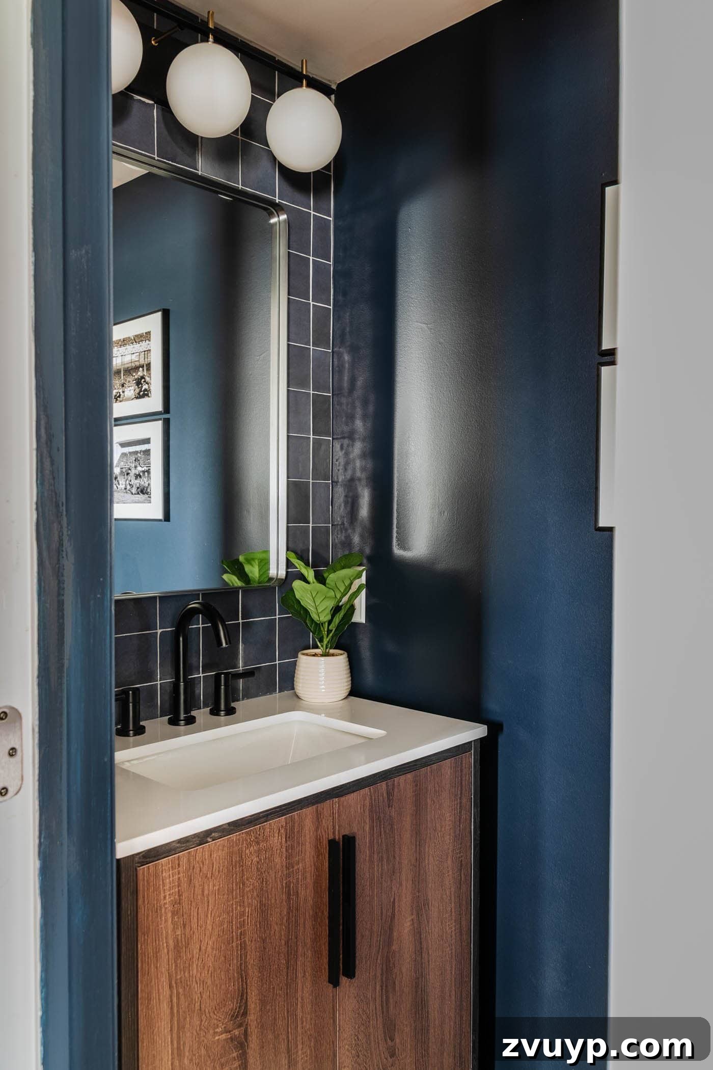 Sleek & Compact: Bachelor Pad Powder Room Makeover 10 stacked tile focal wall behind a vanity in a small bathroom at a bachelor pad, complemented by dark navy blue walls