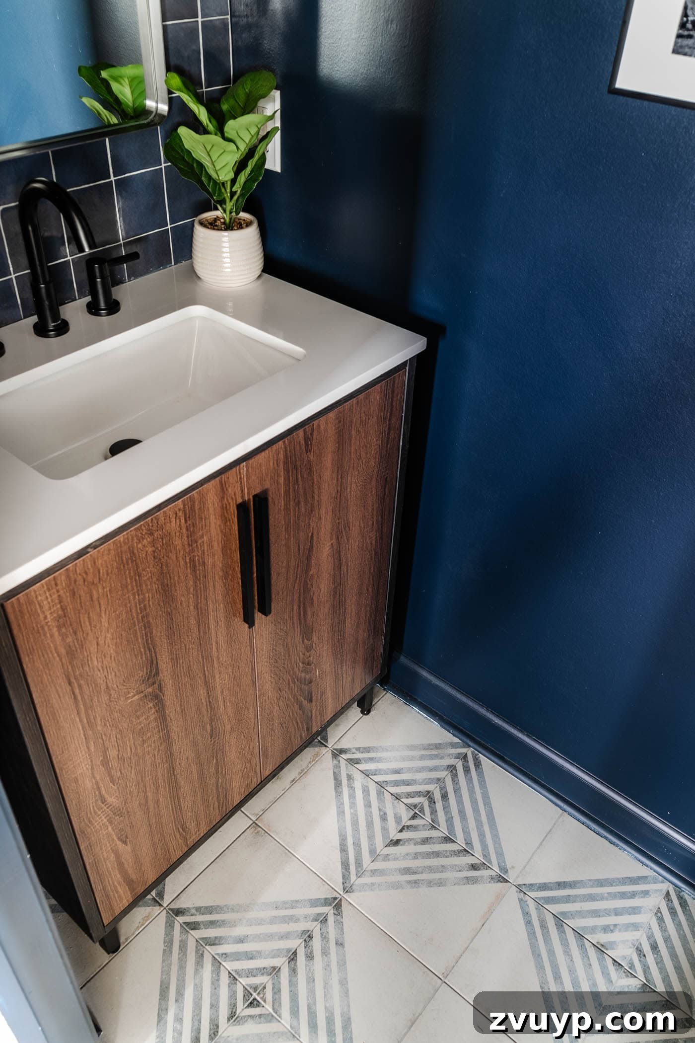 Sleek & Compact: Bachelor Pad Powder Room Makeover 9 patterned tile and wood vanity with navy blue walls, creating a balanced and spacious feel in the compact powder room
