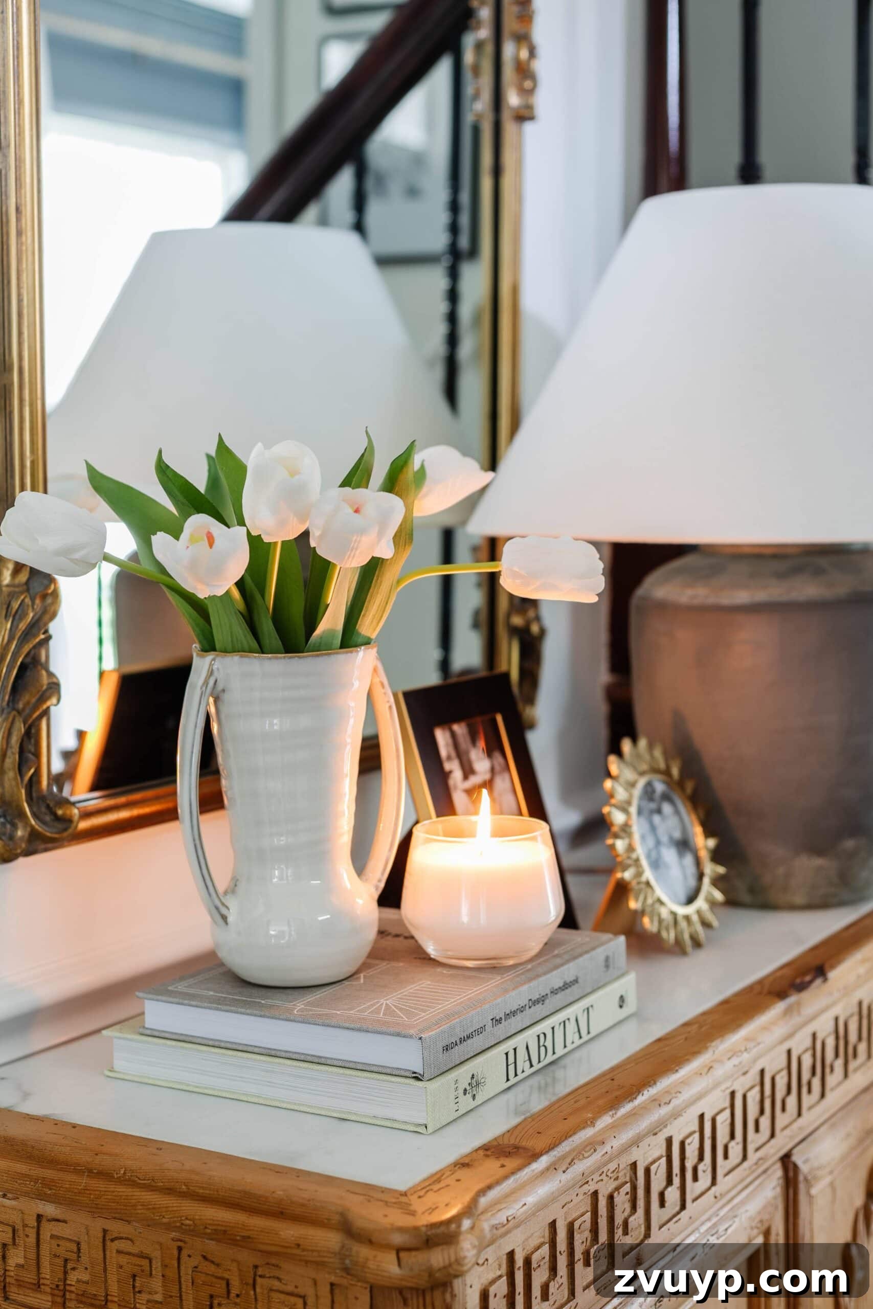 Flawless Fakes: The Secret to Finding Real-Looking Artificial Flowers 4 fake tulips on a tabletop with books and candle, creating a realistic display
