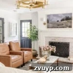 Our Favorite Fandeliers Top-Rated Picks 7 glass and gold fandelier in a living room with limewashed brick fireplace, white walls and black doors, a stylish home decor element