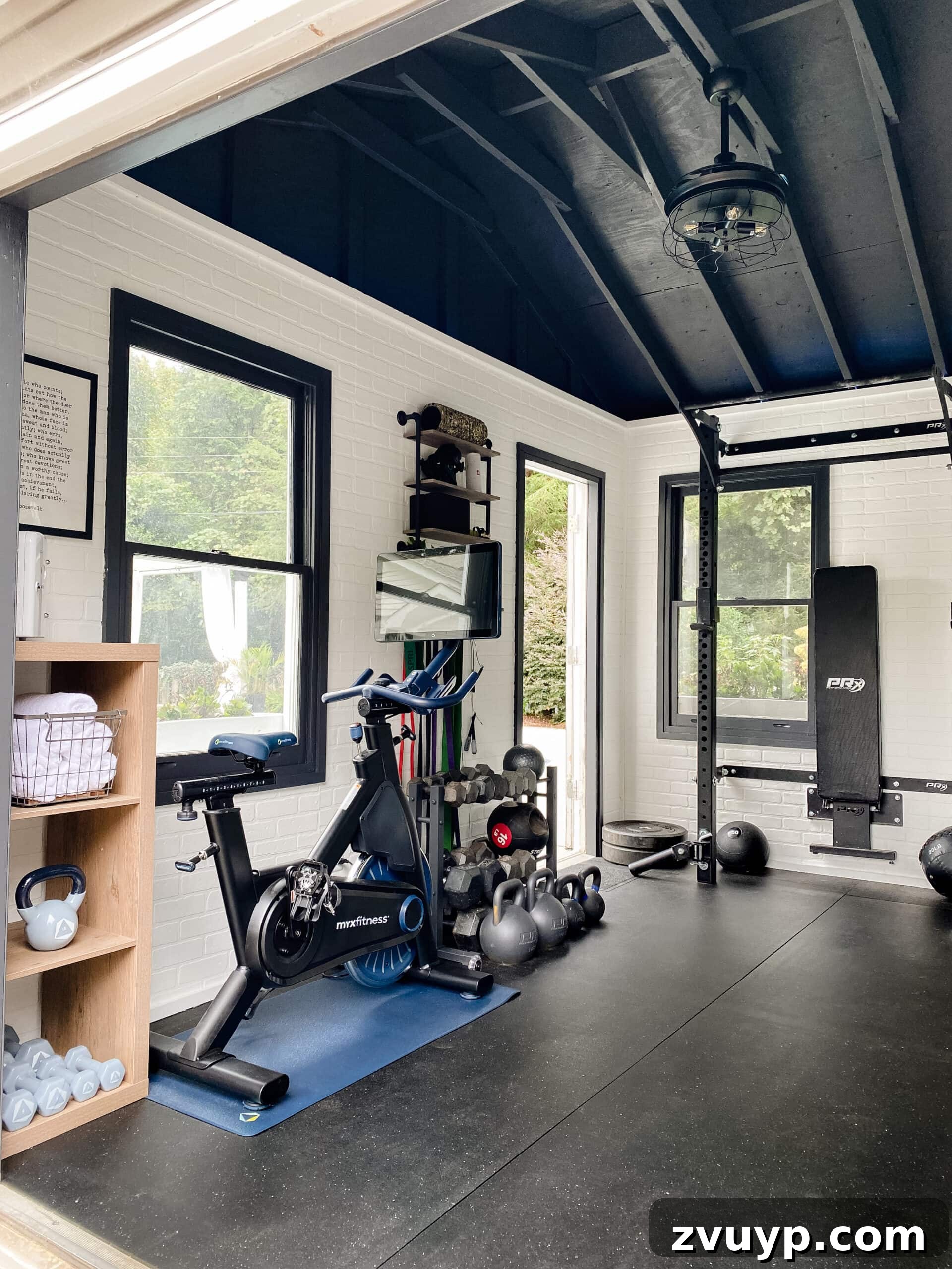 Our Favorite Fandeliers Top-Rated Picks 3 a stylish chandelier ceiling fan with retractable blades in a home gym setting, promoting airflow and safety