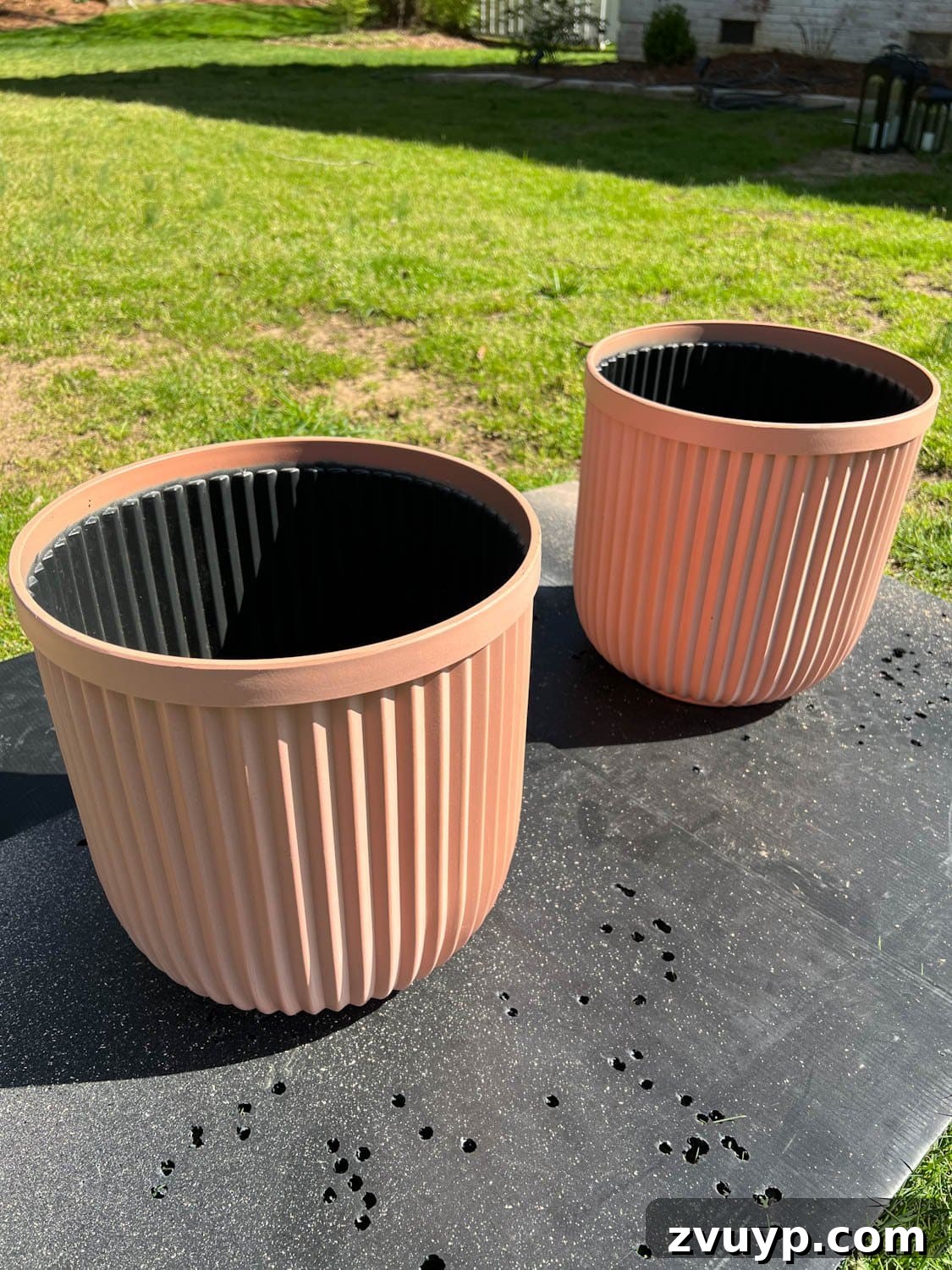 DIY Faux Concrete Planters: The Spray Paint Secret 3 terracotta colored fluted resin planters from Walmart