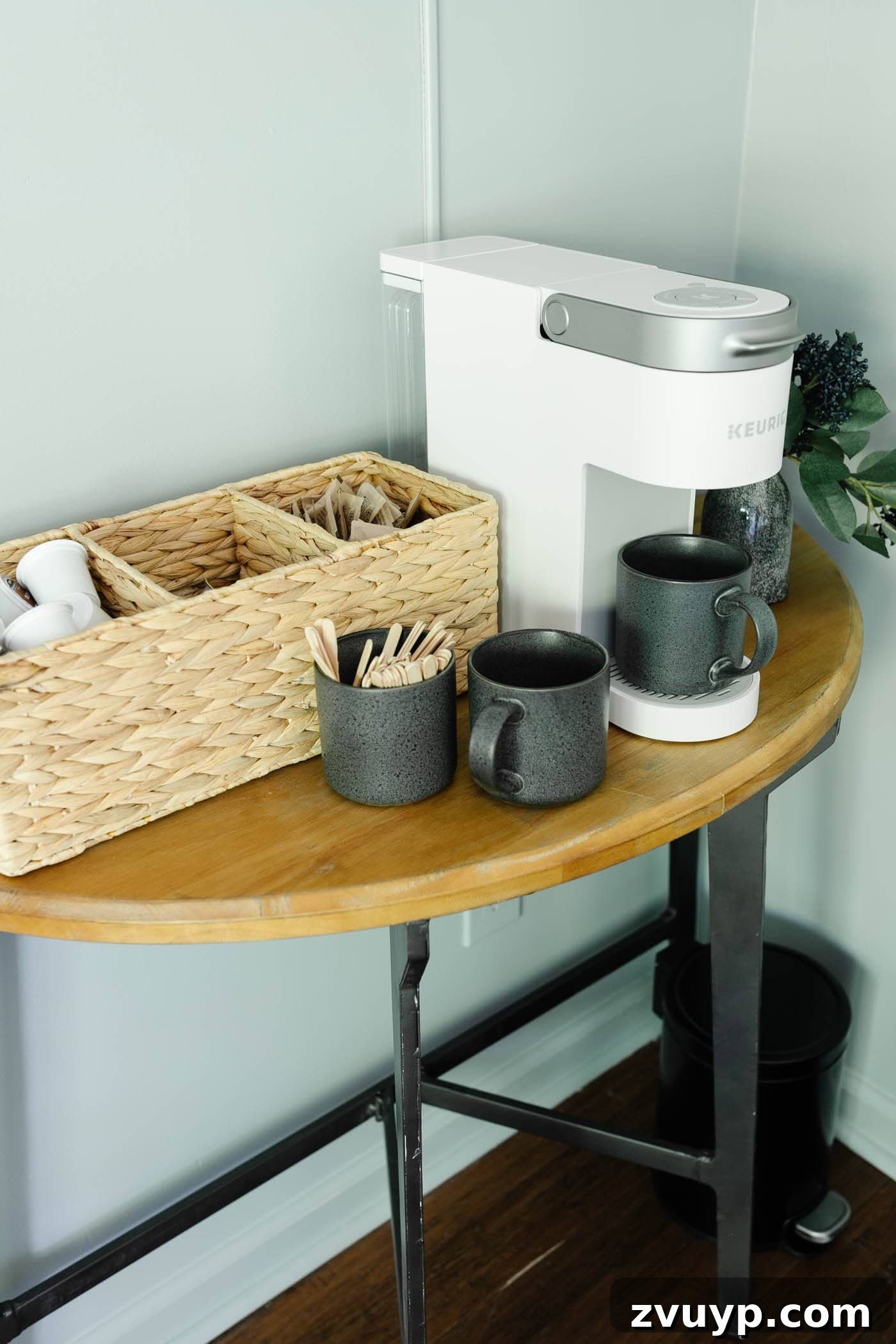8 Productive Retreats: Design Your Home Office Lounge for Focus and Flow 6 Office lounge area featuring a neat coffee bar setup with mugs and a divided basket for coffee essentials, designed to boost productivity
