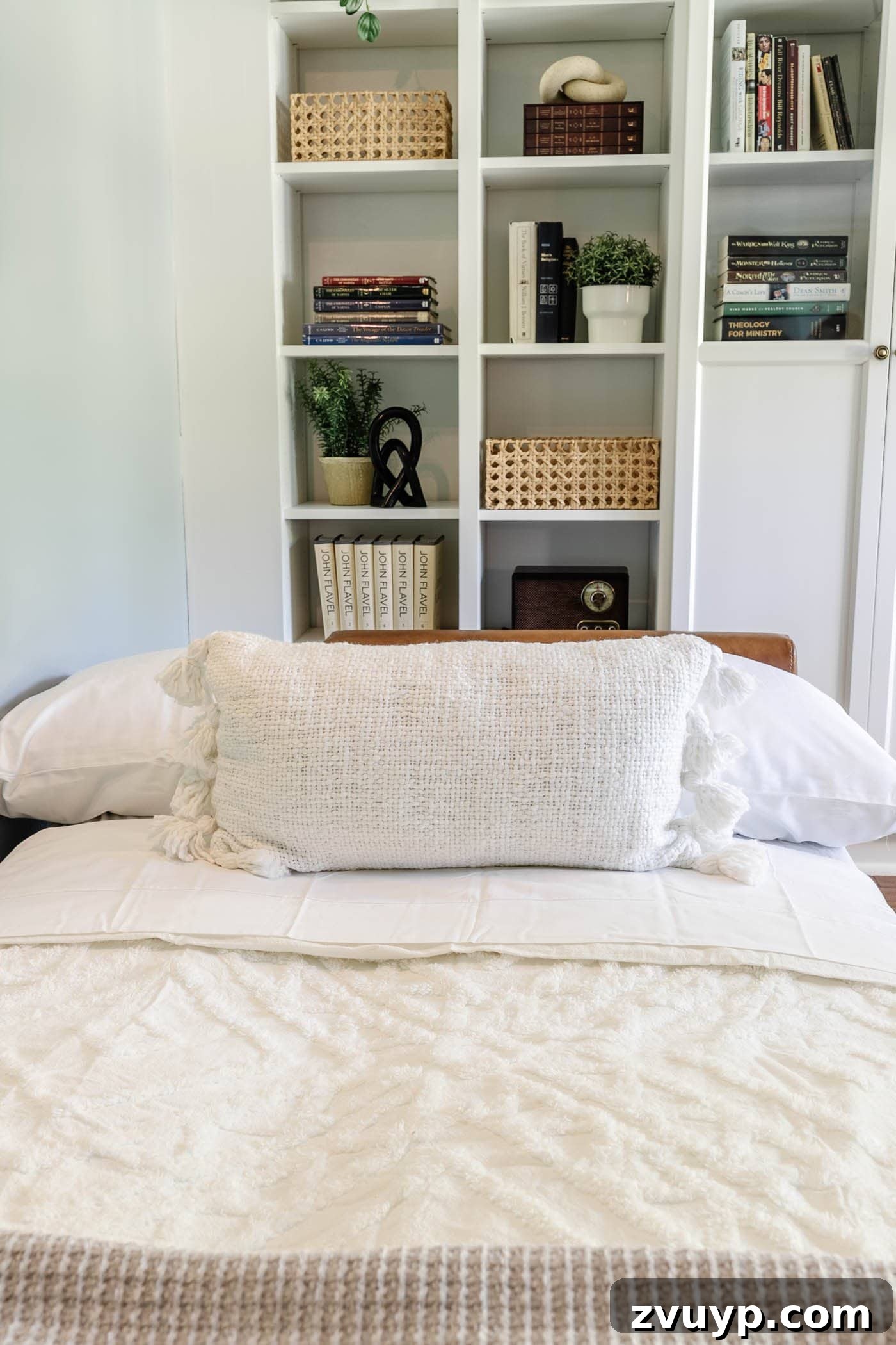 8 Productive Retreats: Design Your Home Office Lounge for Focus and Flow 9 Guest bedding on a futon in an office lounge, adorned with cozy throw pillows for added comfort and style